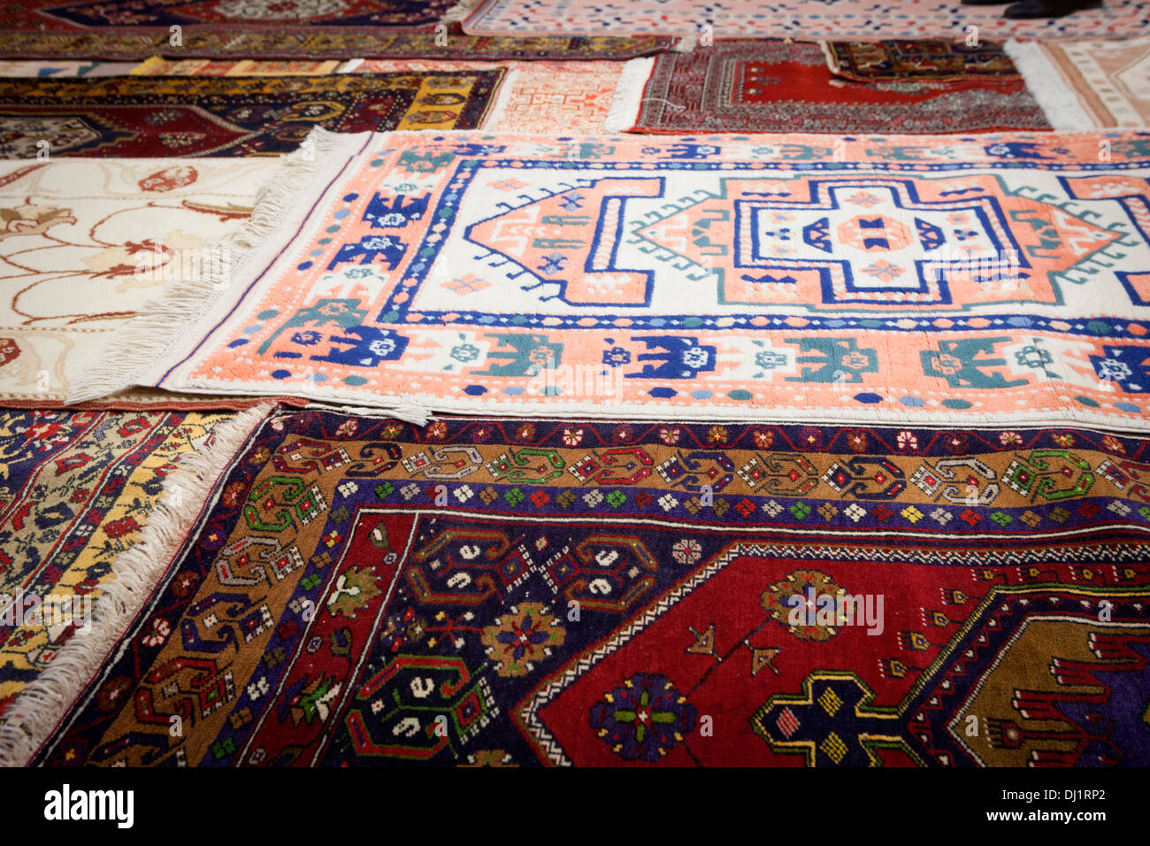 A colourful collection of traditional handloomed carpets displayed at
