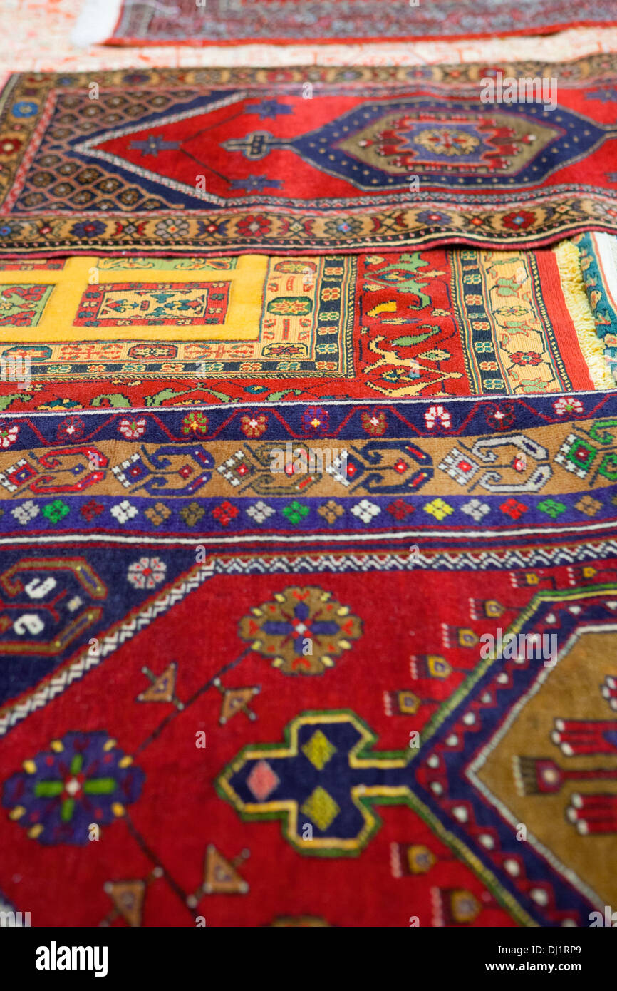 A colourful collection of traditional handloomed carpets displayed at