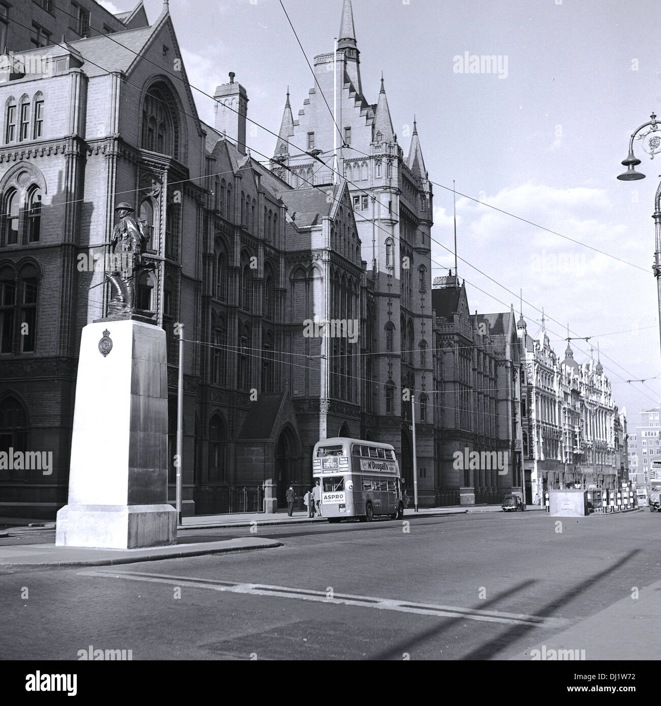 1950s, historical, view from City of London towards the West End showing buildings and a war memorial, a bronze statue on stone plinth of a WW1 solider of the Royal Fusiliers at High Holborn London, England, UK. Further down the empty street, by the victorian gothic revival building of the Prudential Assurance Co, a double-decker London bus of the era. Stock Photo