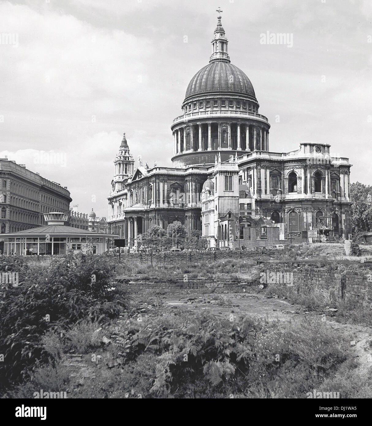 1950s, Historical picture of the exterior of St Paul's Cathedral, London and showing an area of rough ground from WW2 bomb damage next to it. The seat of the Bishop of London, it was designed by Sir Christopher Wren. Stock Photo