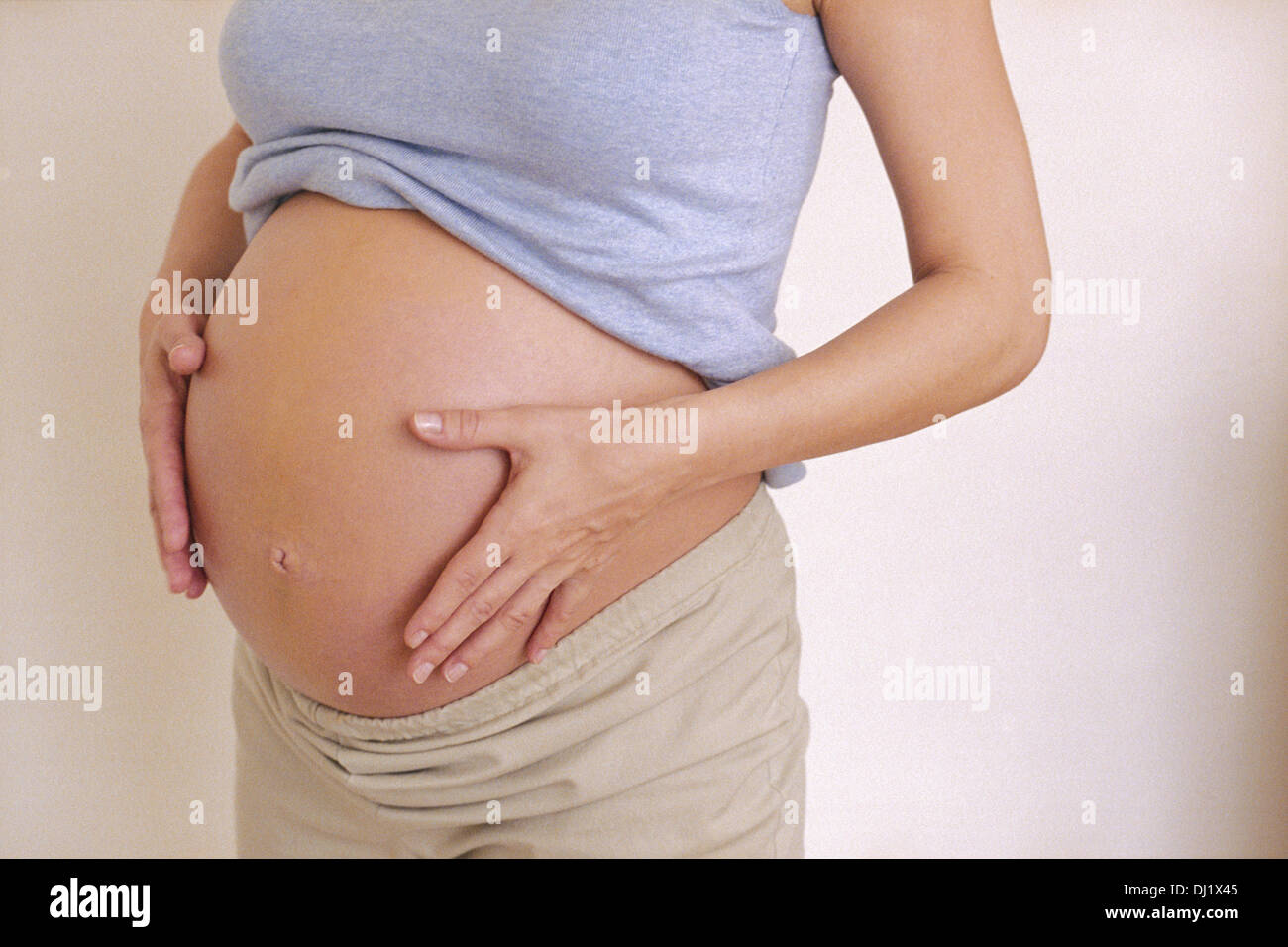 Pregnant Woman Holding Stomach Stock Photo