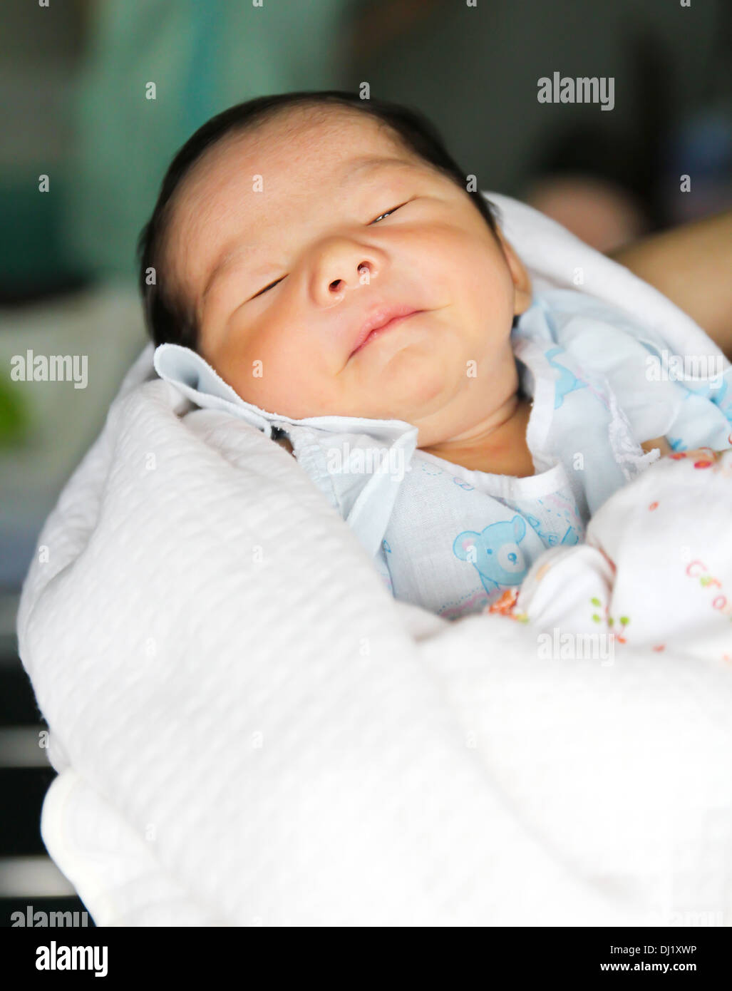 Newborn Asian baby girl sleeping Stock Photo. 