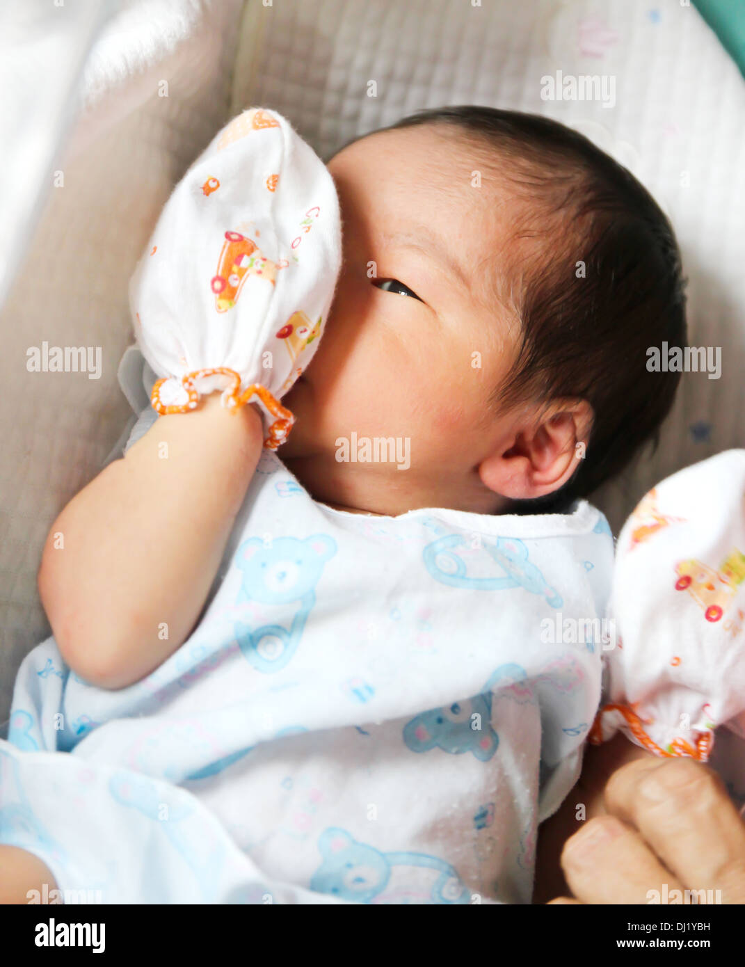 Sleeping newborn girl in the first days of life on a white background. 