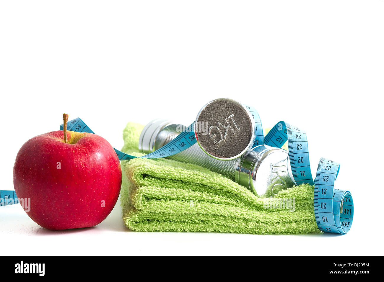 Dumbbells with an apple on a white background. Stock Photo