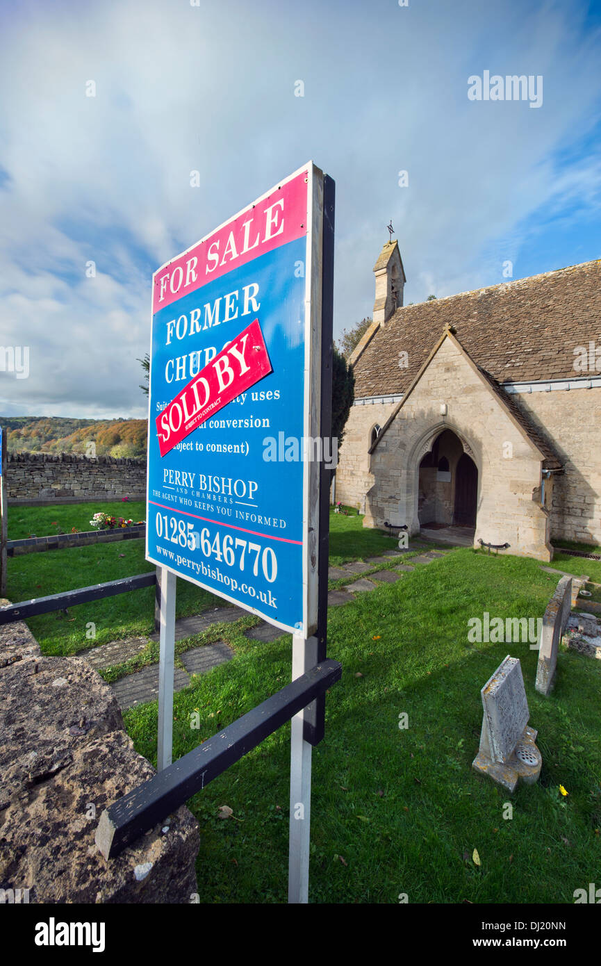 A 'For Sale' and 'Sold' sign on a church in Shortwood near Nailsworth, Gloucestershire UK Stock Photo