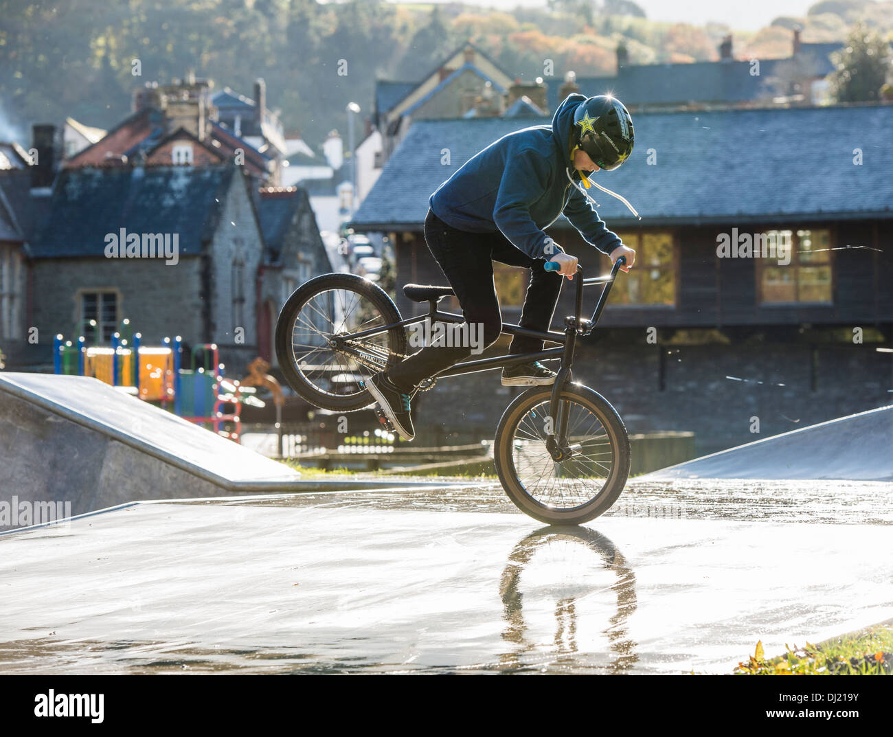 A Teenage boy riding his BMX bike doing foot jam endo stunts at a skateboard /BMX park UK Stock Photo - Alamy