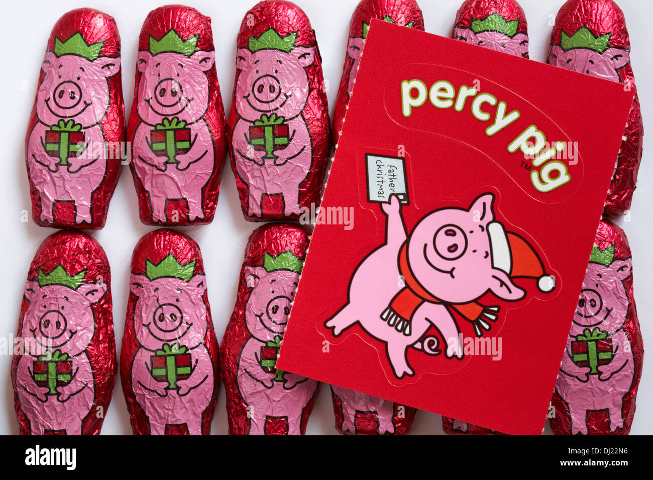 Marks & Spencer percy in the pink solid percy pig shapes made with flavoured white chocolate & dried raspberries with sticker Stock Photo