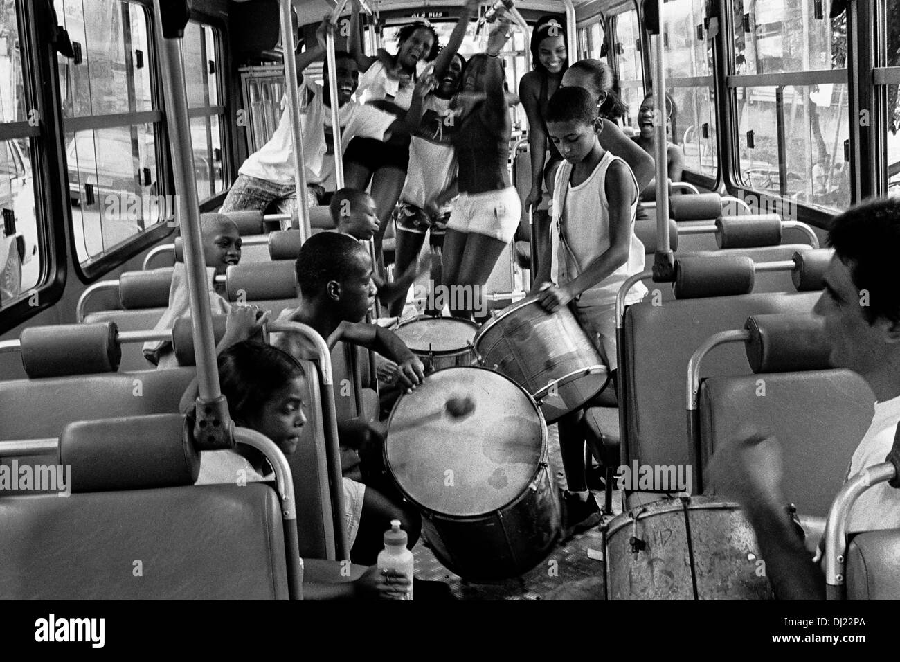 Young Brazilian people dance samba and play drums in a public bus on the street of Rio de Janeiro, Brazil. Stock Photo