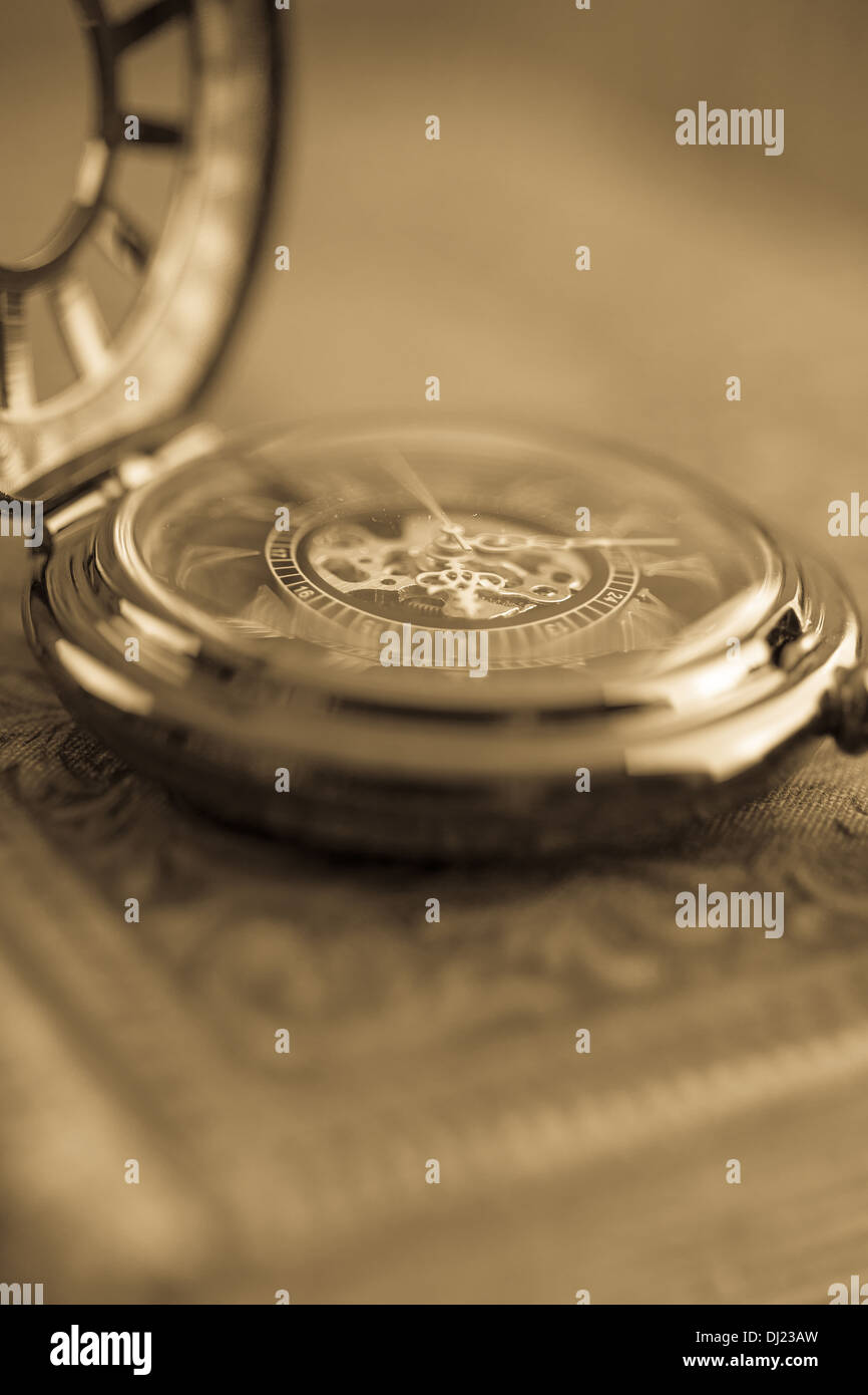 Blurry close up of a antique pocket watch with warm sepia tones. Stock Photo