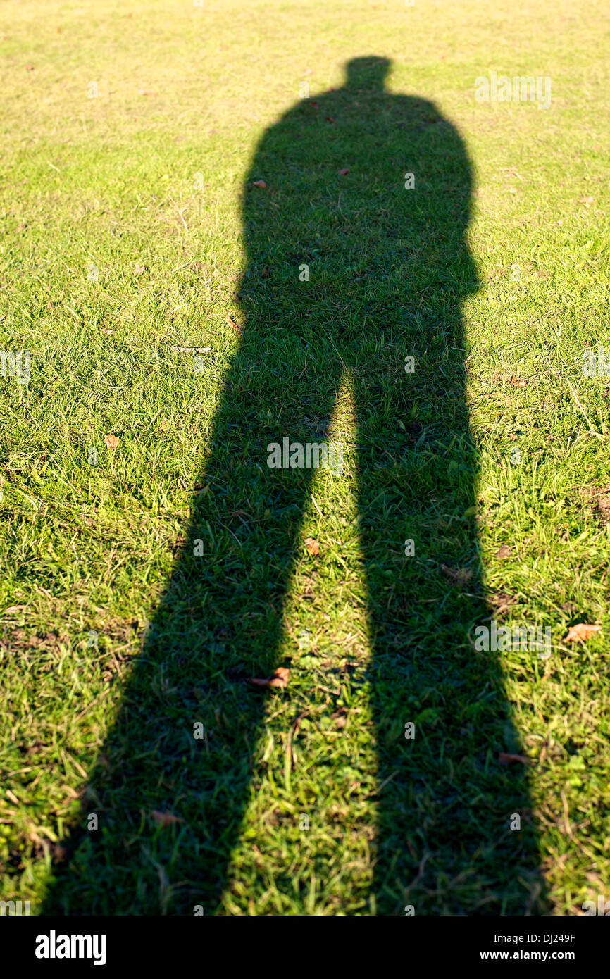 Man's shadow on grass Stock Photo - Alamy