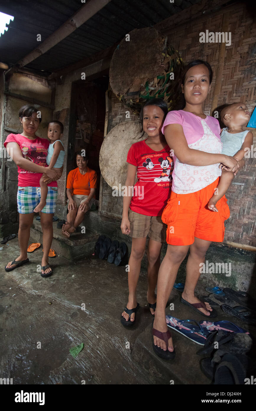 Mother child poor Bali poverty challenged extreme hold feed poor bellow standard Indonesia 29 house conditions harsh filthy Stock Photo