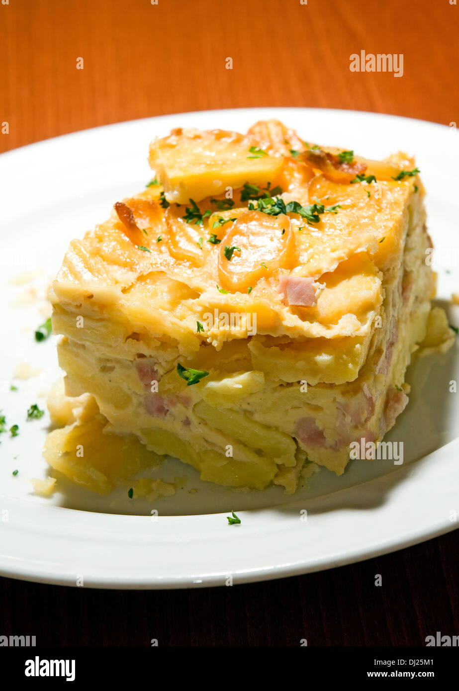 Czech Republic food specialty baked sliced potato smoked bacon bits photographed Prague Castle authentic typical delicacy Prague Stock Photo