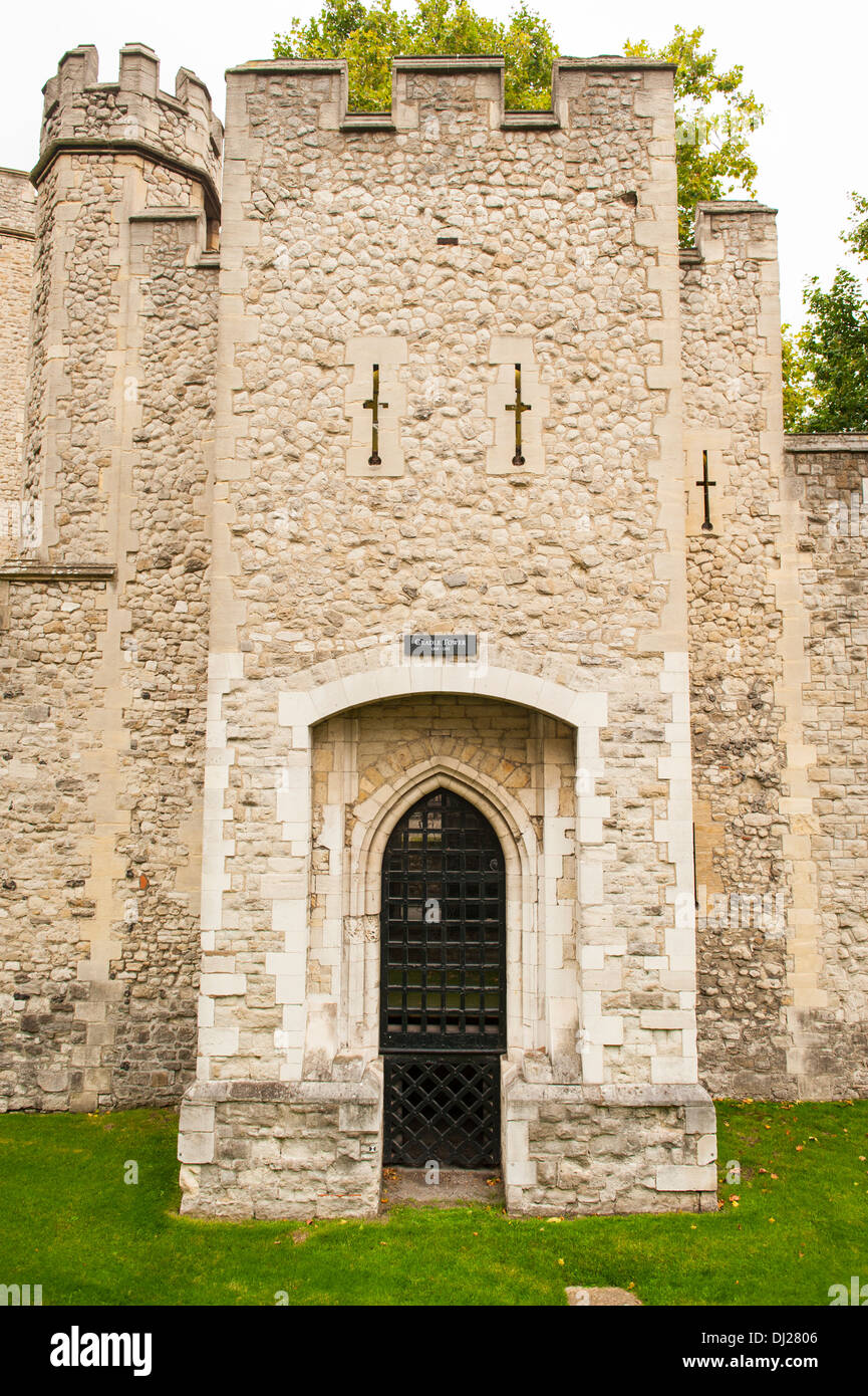 City Tower of London The Cradle Tower fort castle citadel built 1355 parapets arrow slits tree trees blue sky grass lawn black barred gate door stone Stock Photo