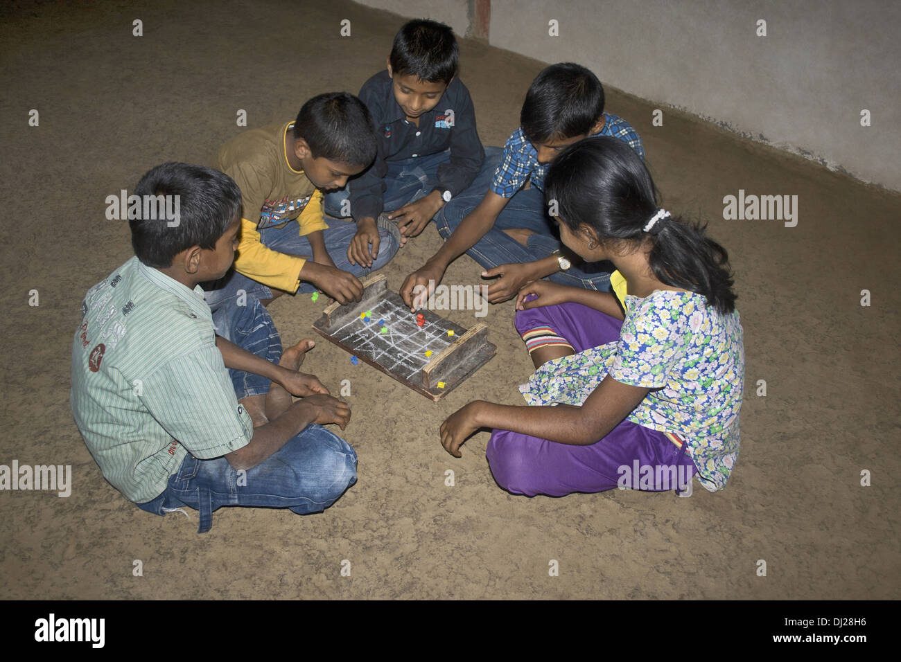 Children playing indoor game Pat (Ludo), Pabal, Pune, Maharashtra, India Stock Photo