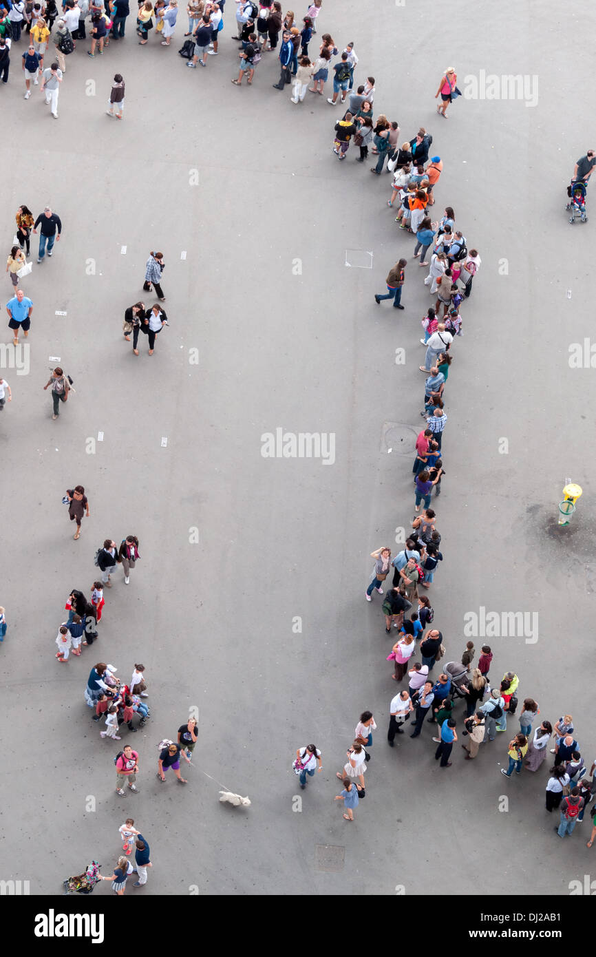 Downwards shot of large crowd of people queuing to go to Eiffel tower. Stock Photo