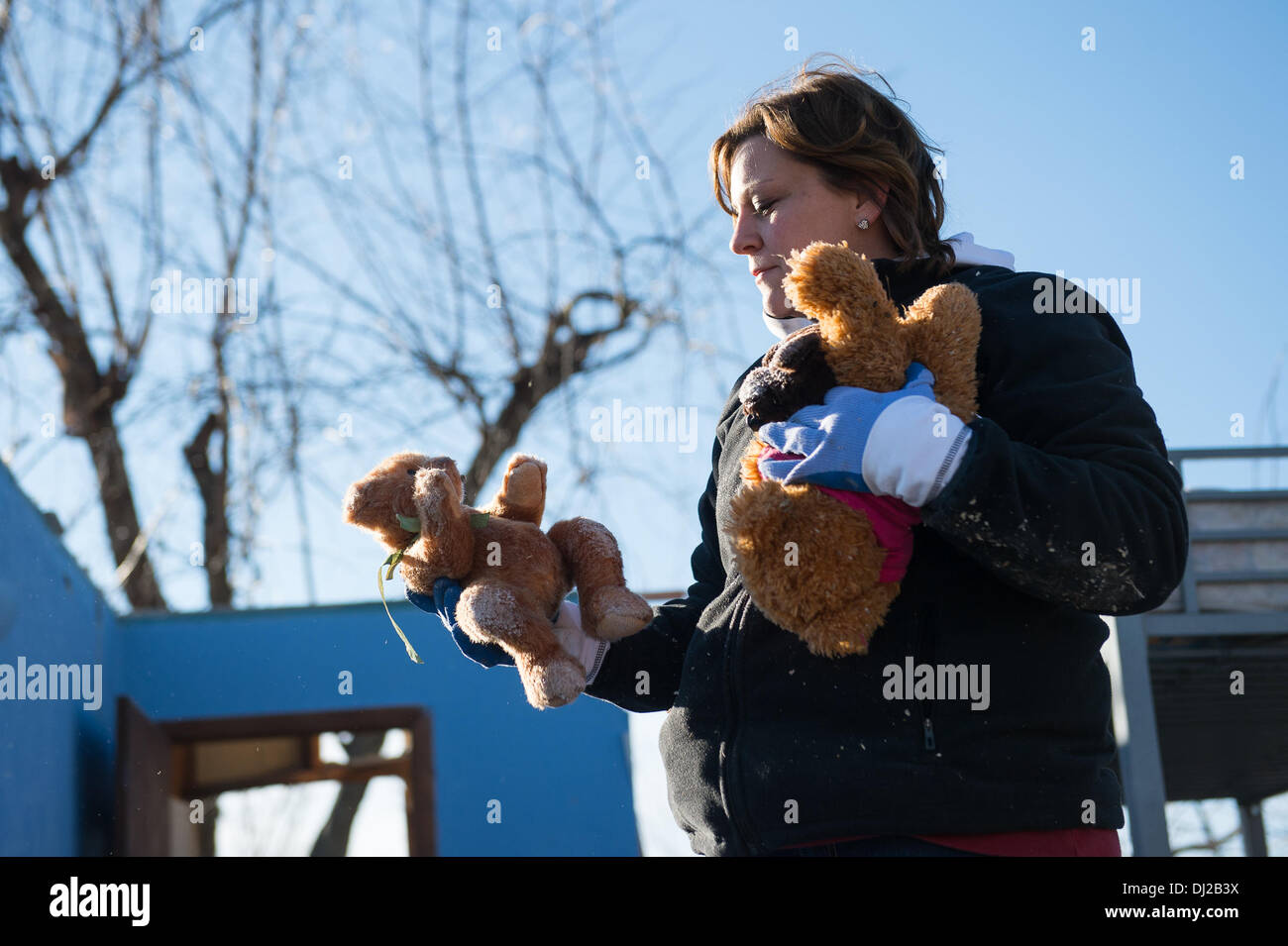 Washington, Illinois, USA. 19th Nov, 2013. SHANNON WILLIAM holds a few Teddy Bears that she found in the rubble of her home on Fayette Ave as she looks for belongings destroyed from the tornado that hit Sunday. A violent storm brought 81 tornadoes throughout the Midwest killing six people and damaging or destroying thousands of homes. © Courtney Sacco/ZUMAPRESS.com/Alamy Live News Stock Photo