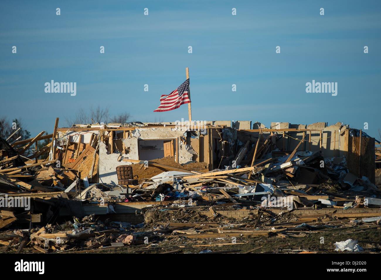 Washington, IL, USA. 19th Nov, 2013. A flag flies over a what is left of a home in Washington Illinois as the sun starts to set on first day the residents have returned since the Tornado Sunday. Credit:  Courtney Sacco/ZUMAPRESS.com/Alamy Live News Stock Photo