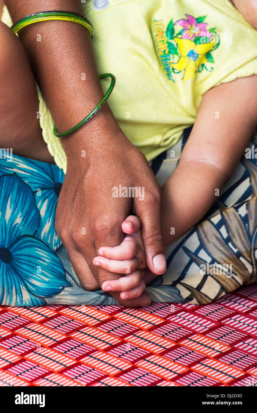 Rural indian mother and baby holding hands. Andhra Pradesh, India Stock Photo