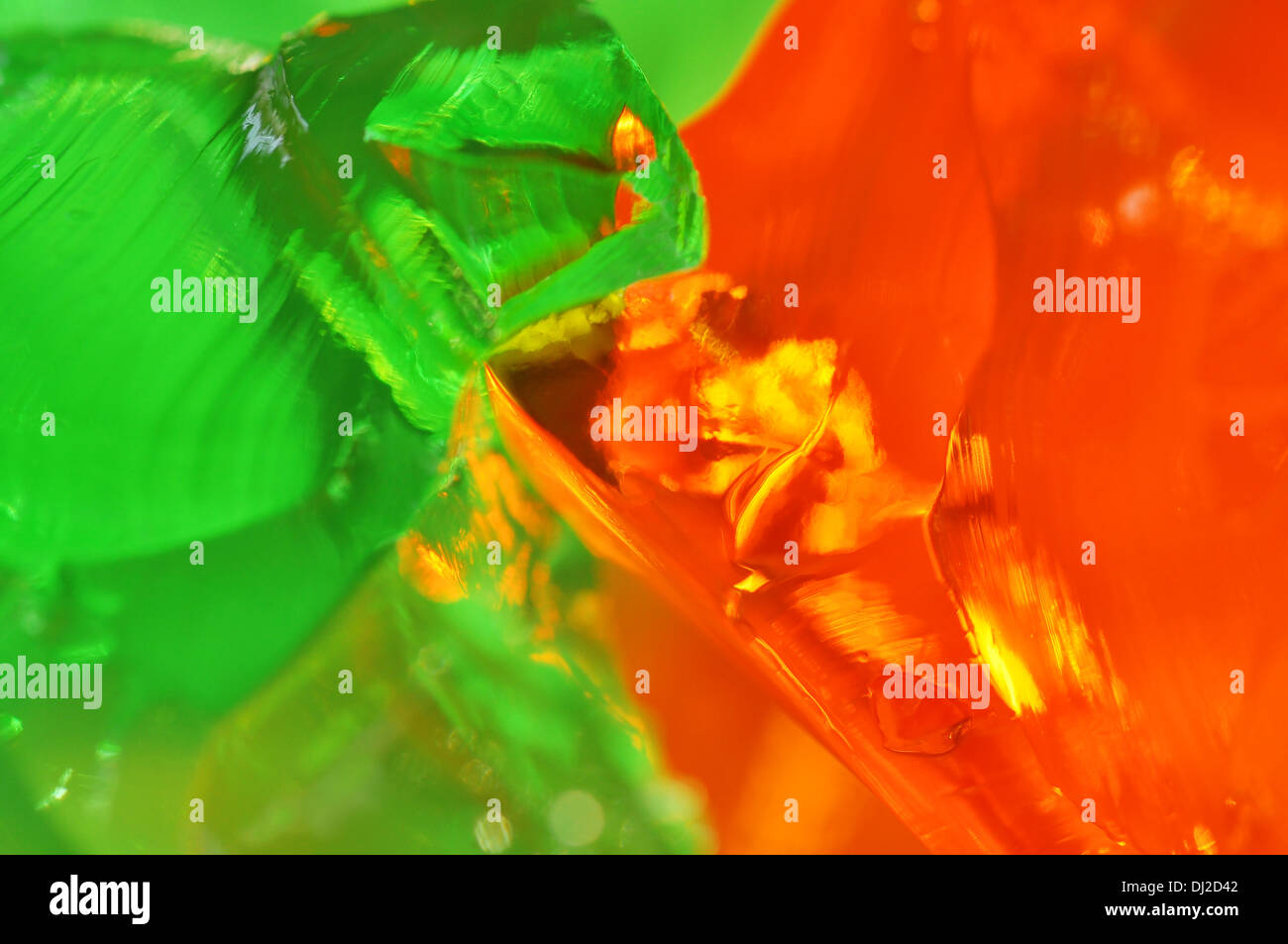 Macro of green lime and orange jelly or gelatin, fun abstract food background Stock Photo