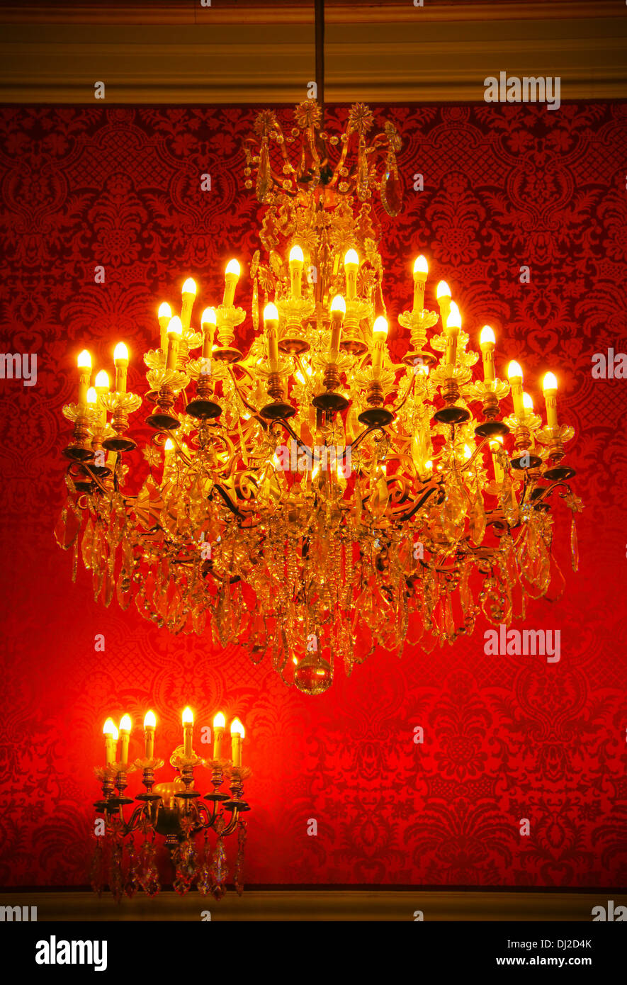 Real lavish crystal chandelier of French castle with tapestry and gold trim Stock Photo