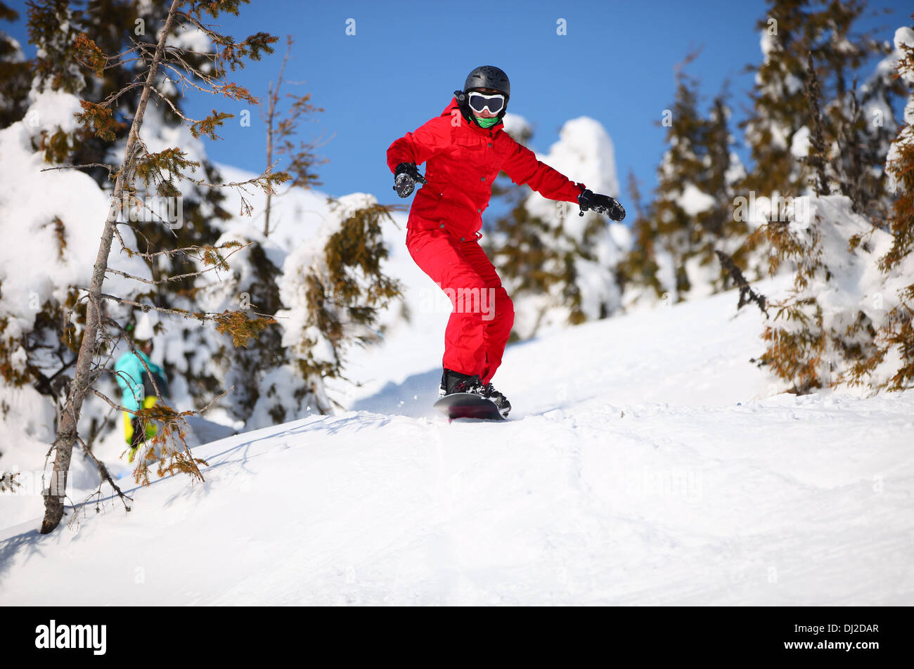 Female snowboarder going to jump on mountain slope Stock Photo Alamy