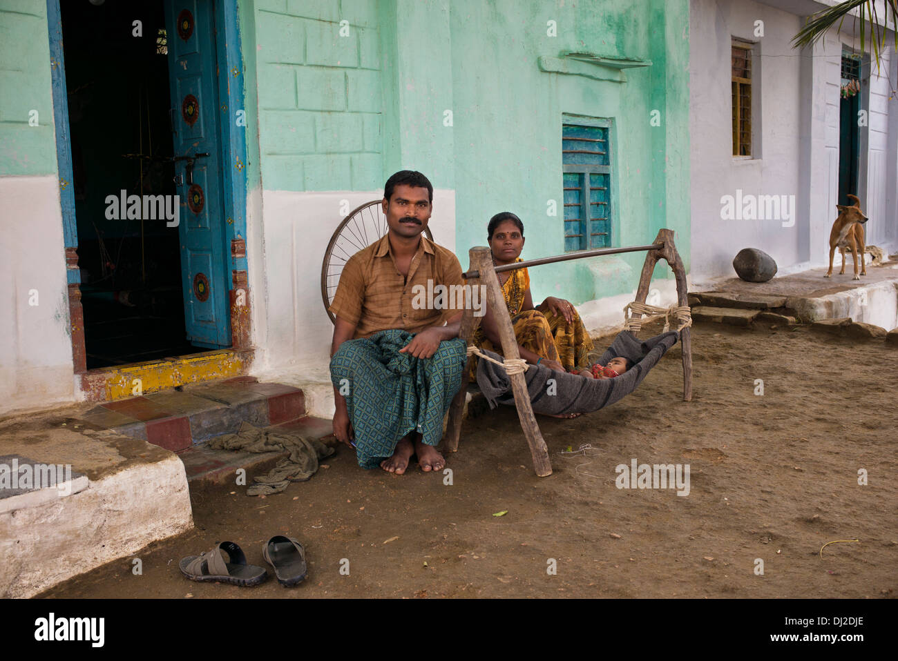 Indian family with baby in a homemade cradle in a rural indian village. Andhra Pradesh, India Stock Photo