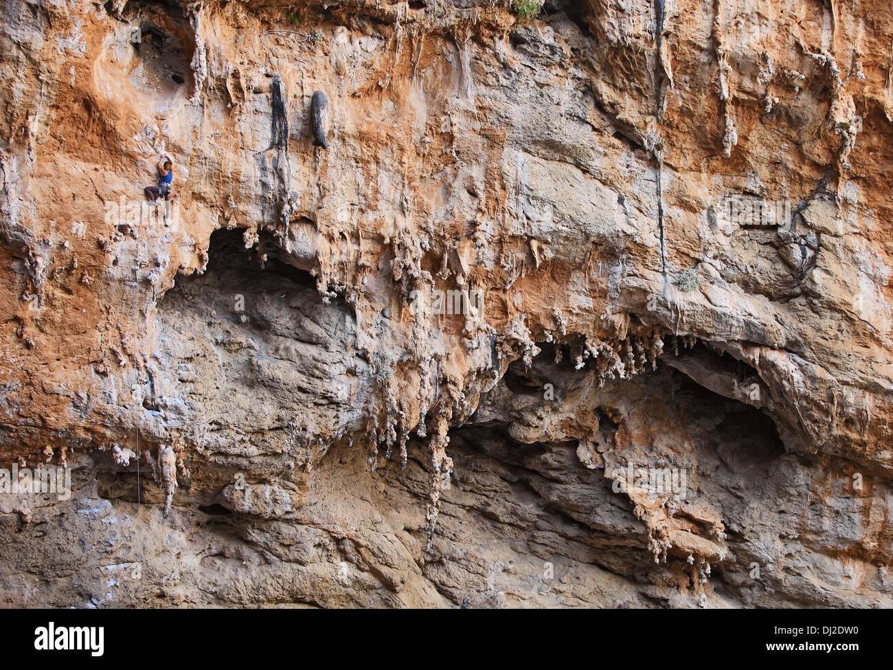 Female rock climber on a cliff face Stock Photo