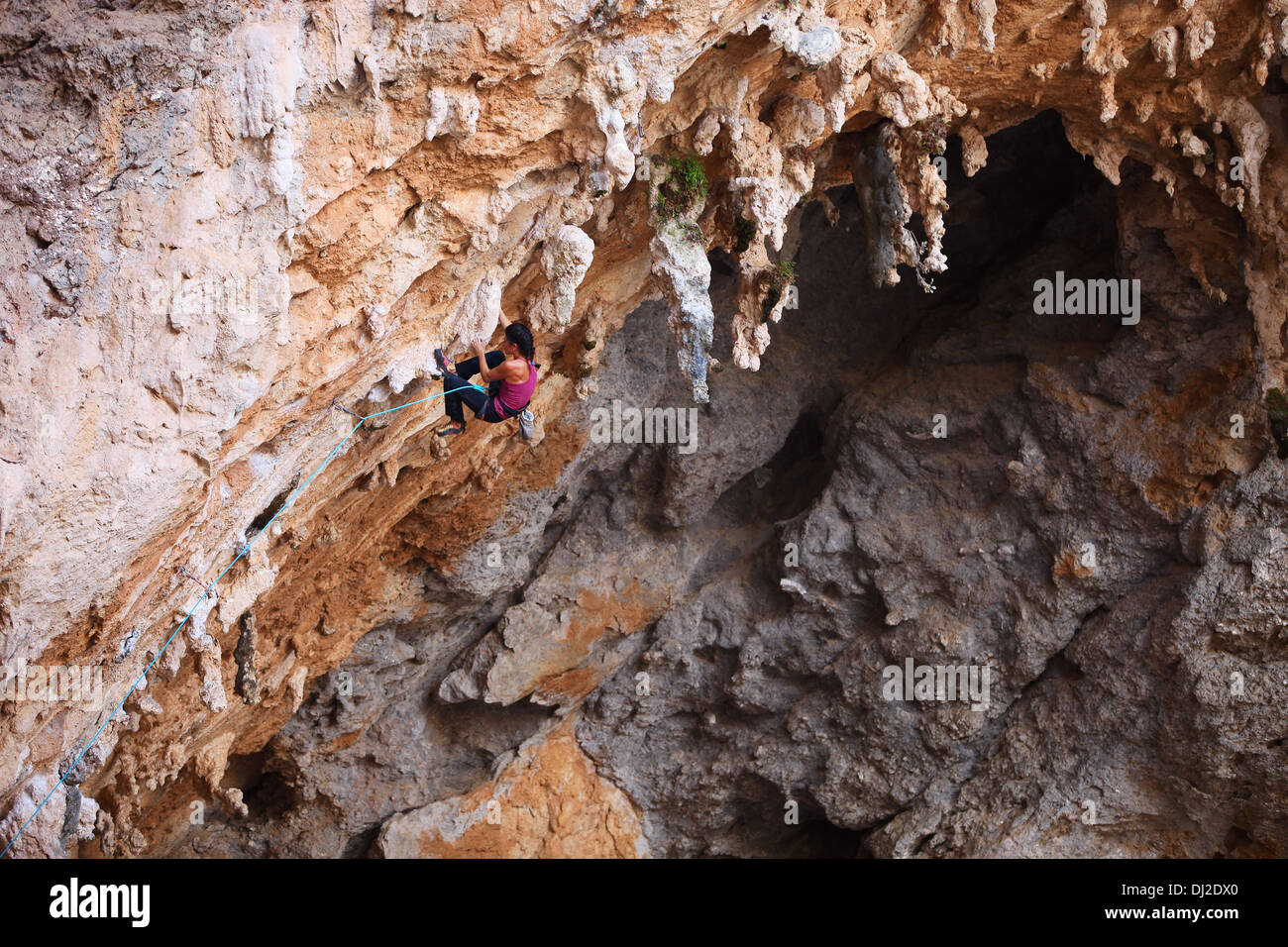 Female rock climber on a cliff face Stock Photo