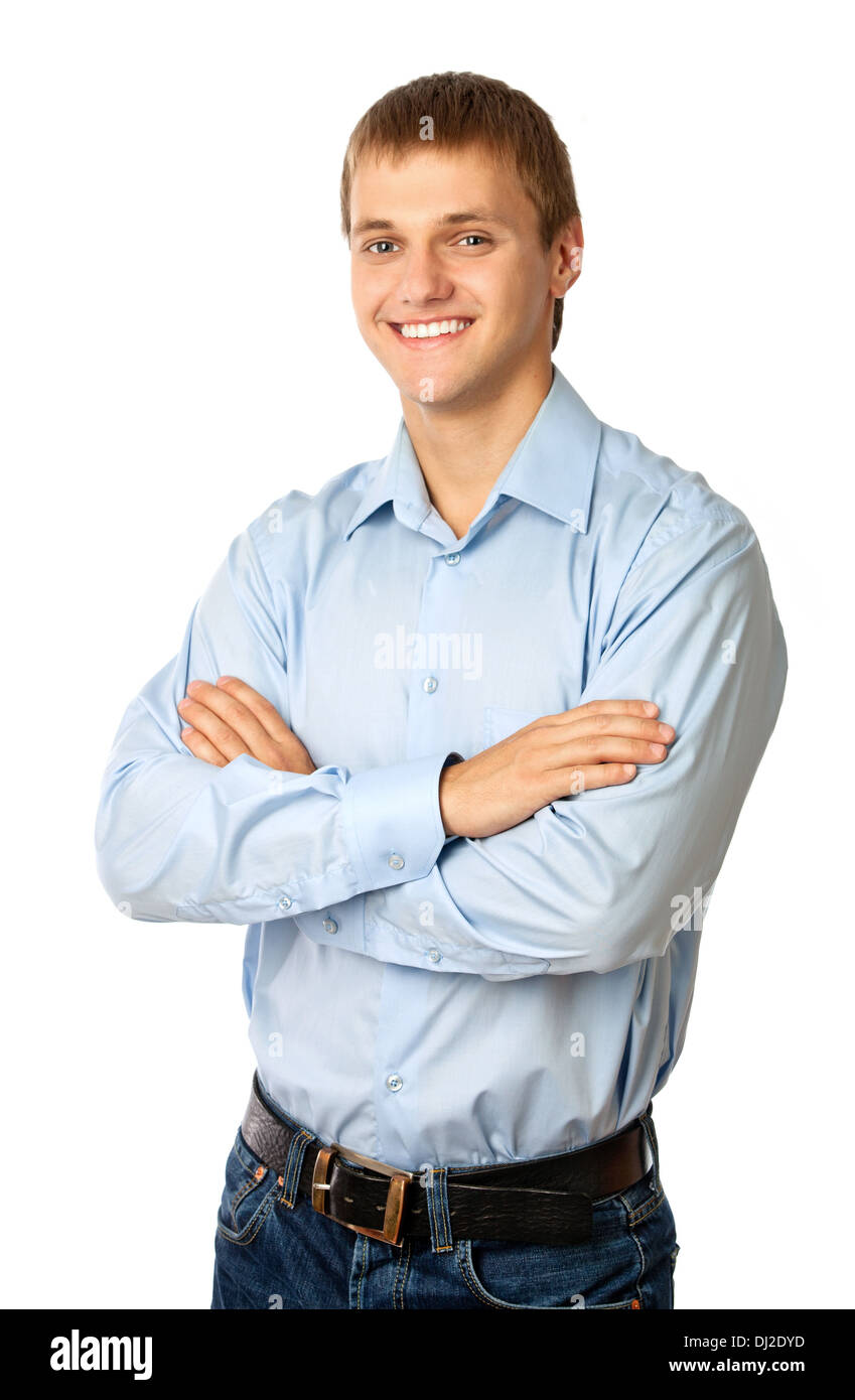 Smiling young man standing with his arms folded against white Stock ...