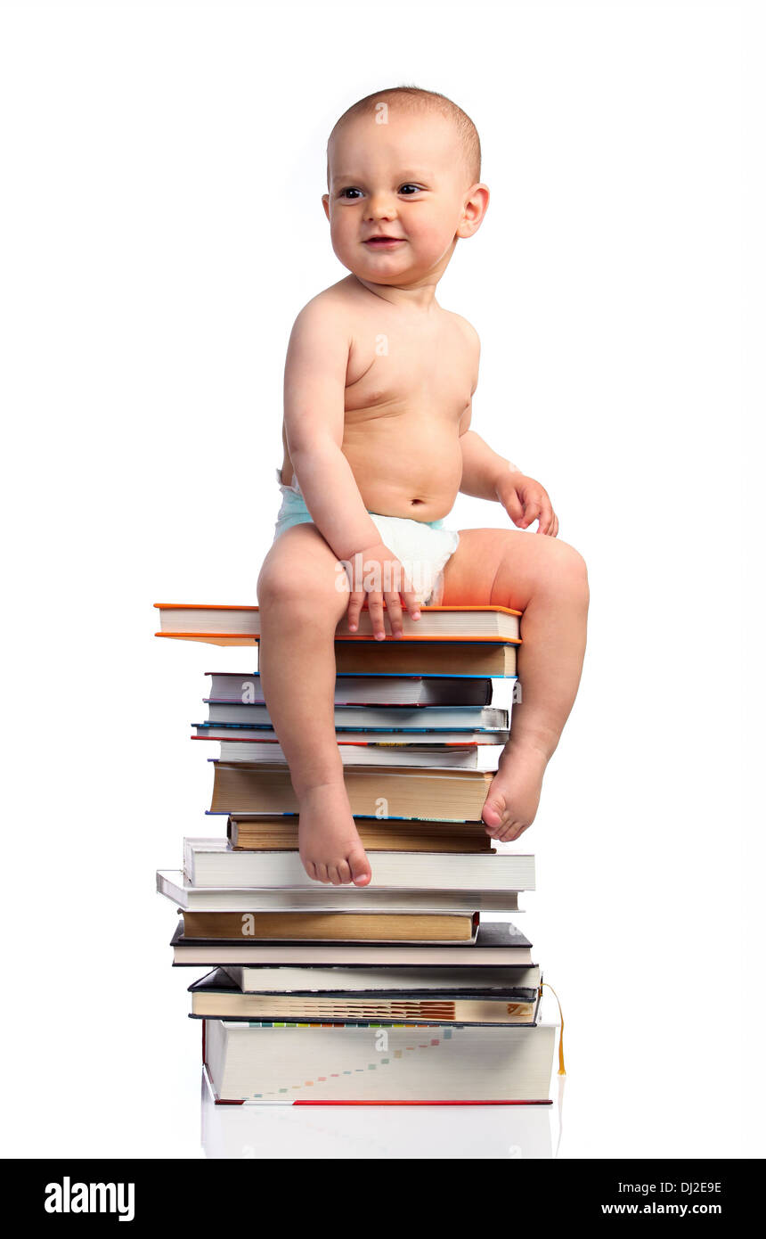 Portrait of a little boy sitting on a stack of book Stock Photo - Alamy