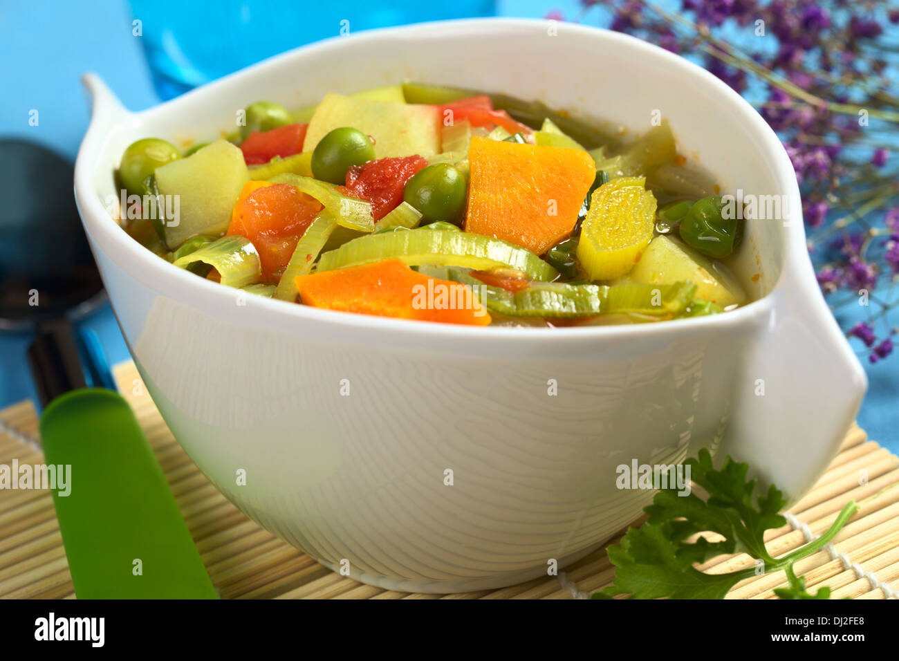 Fresh homemade vegetable soup made of carrot, leek, pea, potato, onion and tomato (Selective Focus) Stock Photo