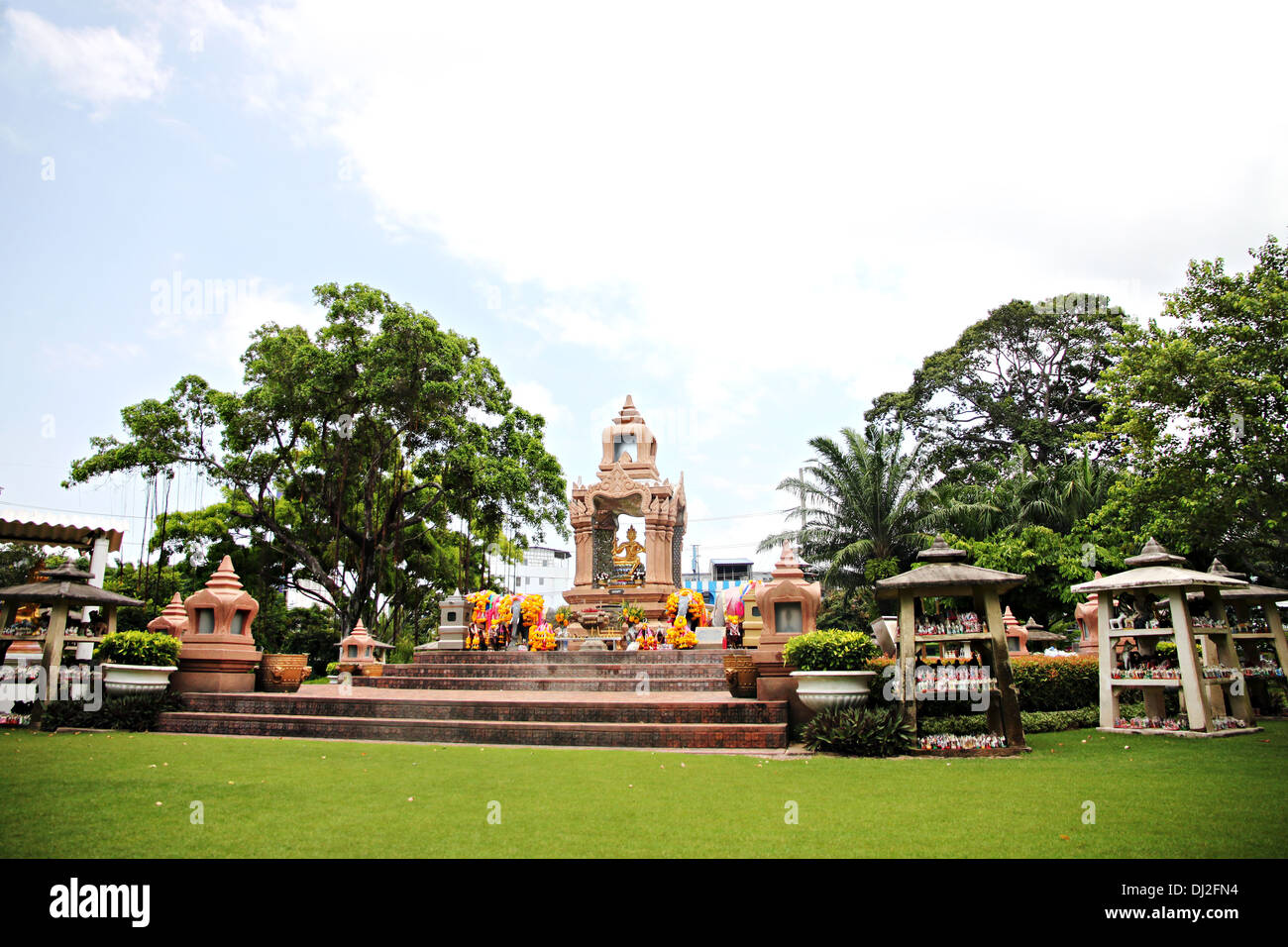 Gold statue of Brahma is located in the park and people place to worship. Stock Photo