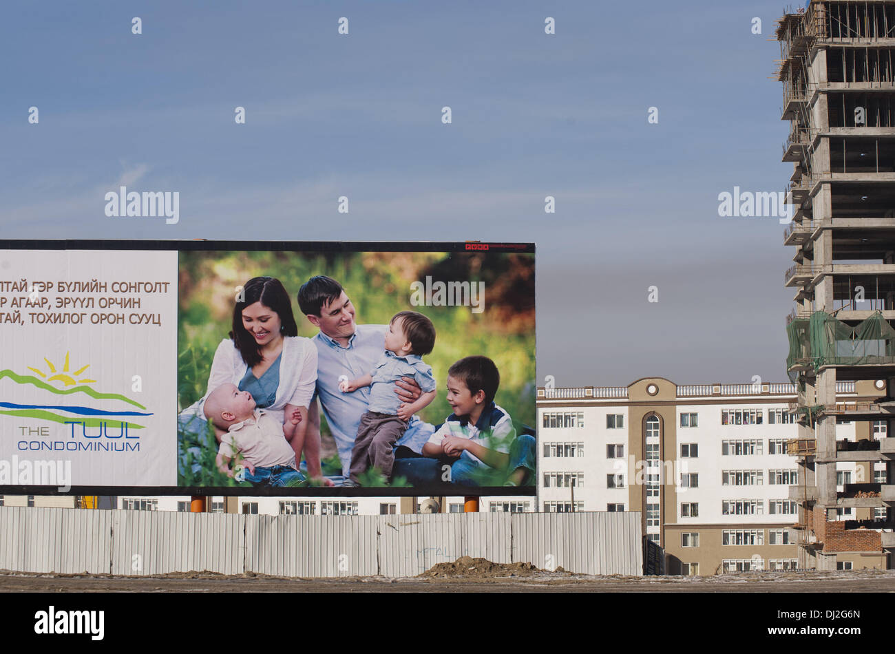 An advertisement board depicts the modern happy family life at a new