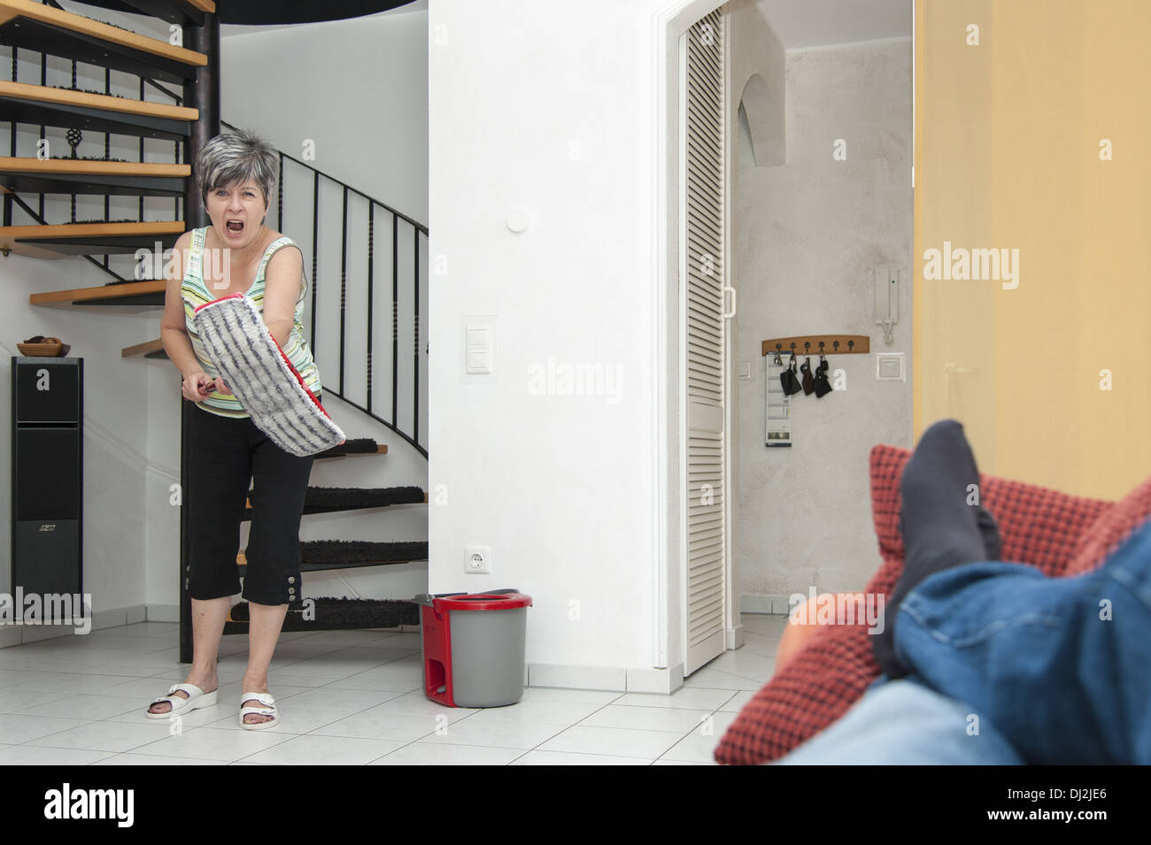 a woman gets into a rage while cleaning Stock Photo