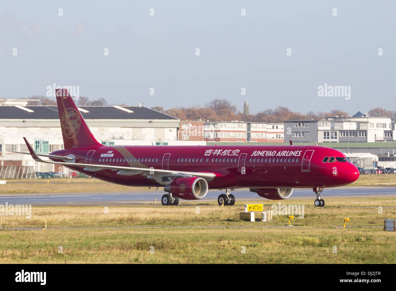 HAMBURG, GERMANY - NOVEMBER 13, 2013: A brand new Airbus A321 for chinese Juneao Airlines taxiing on the Airbus plant in Hamburg Stock Photo