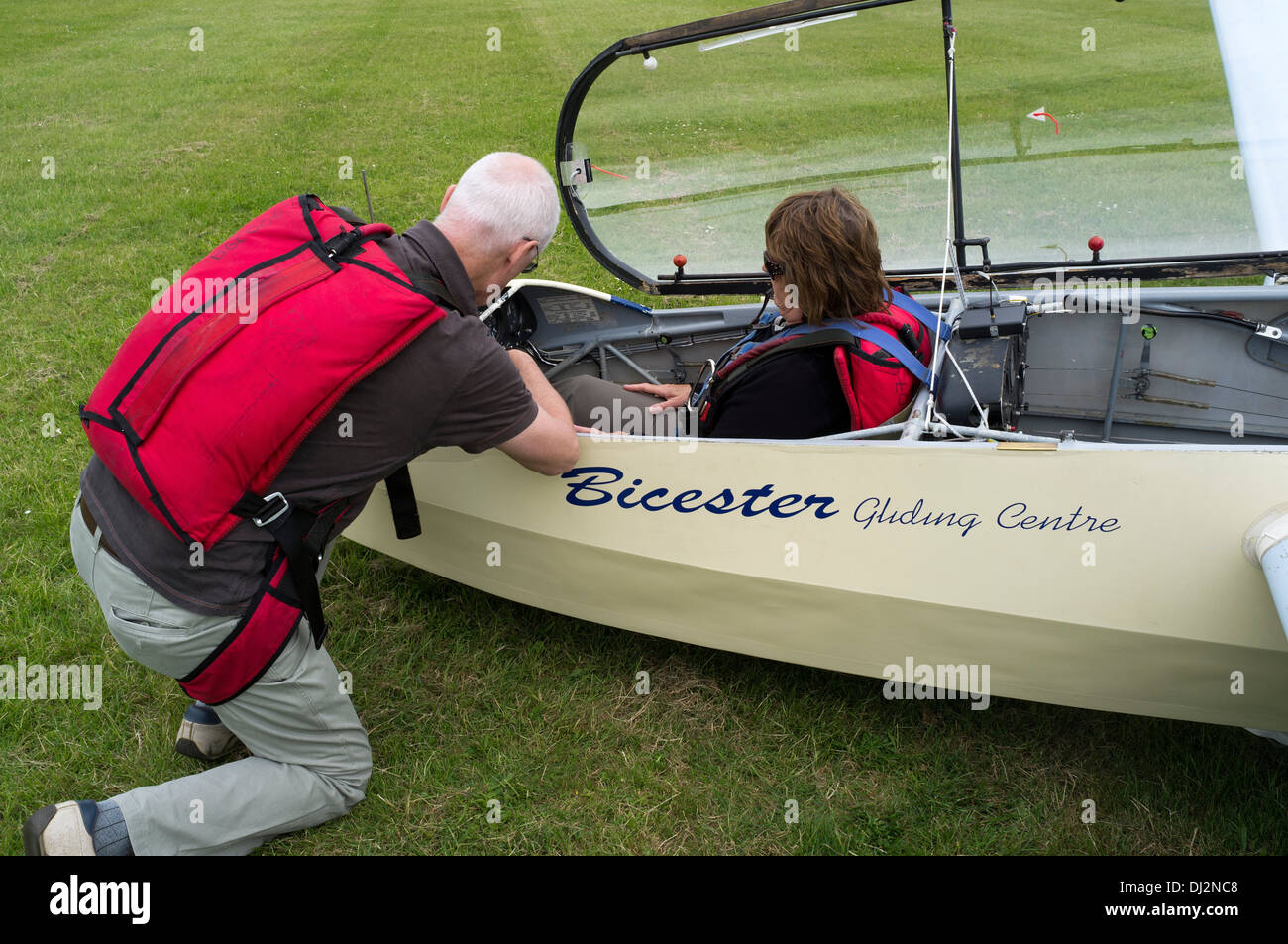 dh GLIDING UK Flying instructor showing woman glider cockpit controls