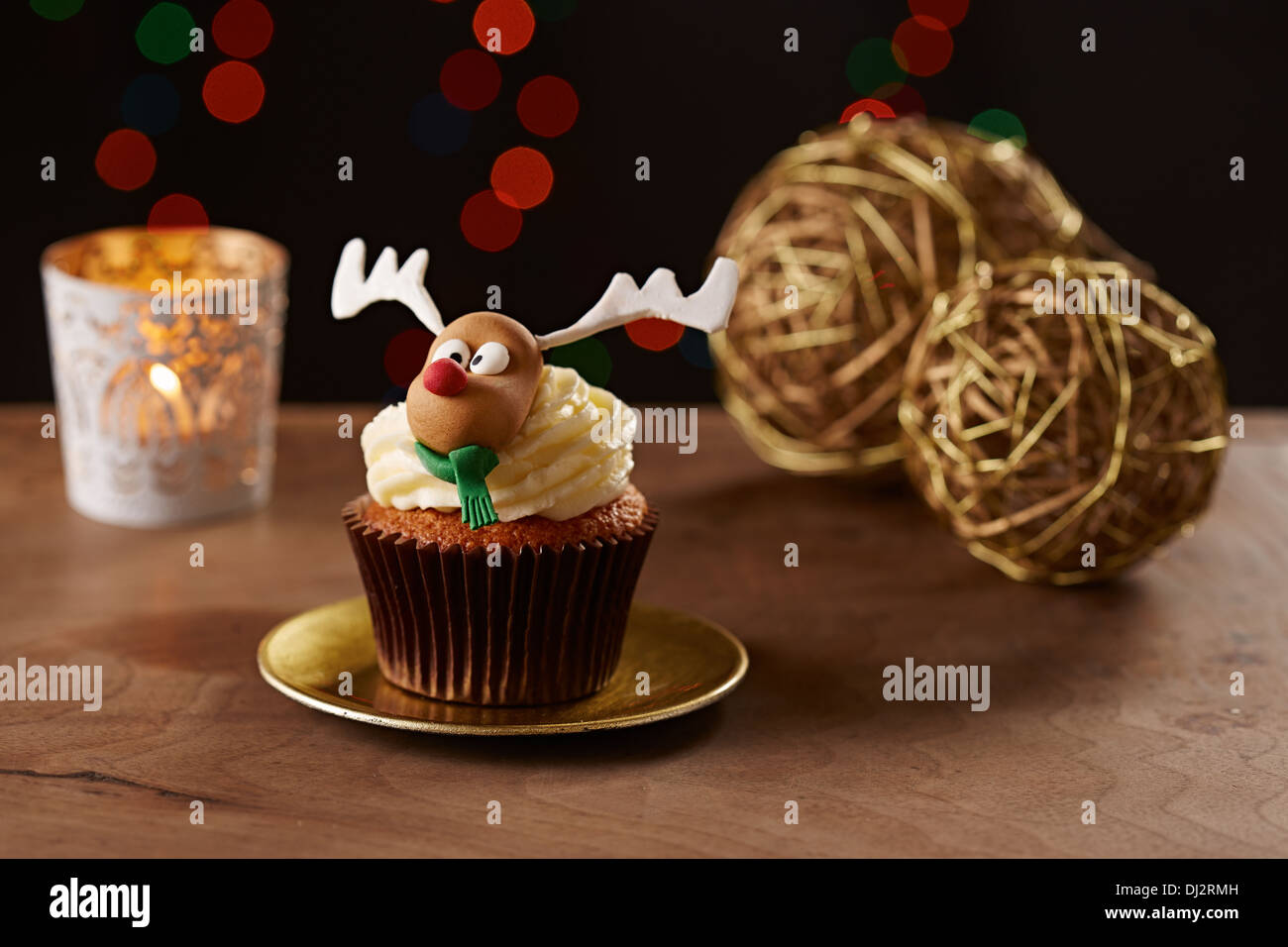 Rudolph reindeer cupcake on black Christmas background Stock Photo