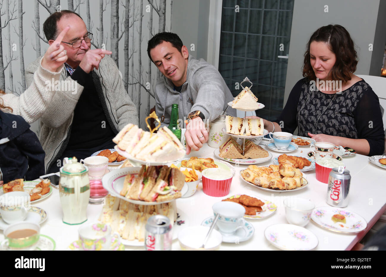 Family around the table having afternoon tea Stock Photo