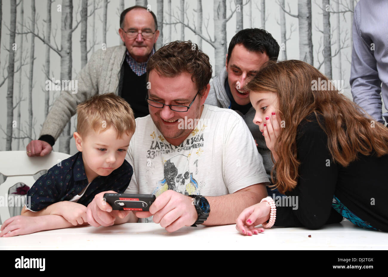 Family looking at a game Stock Photo