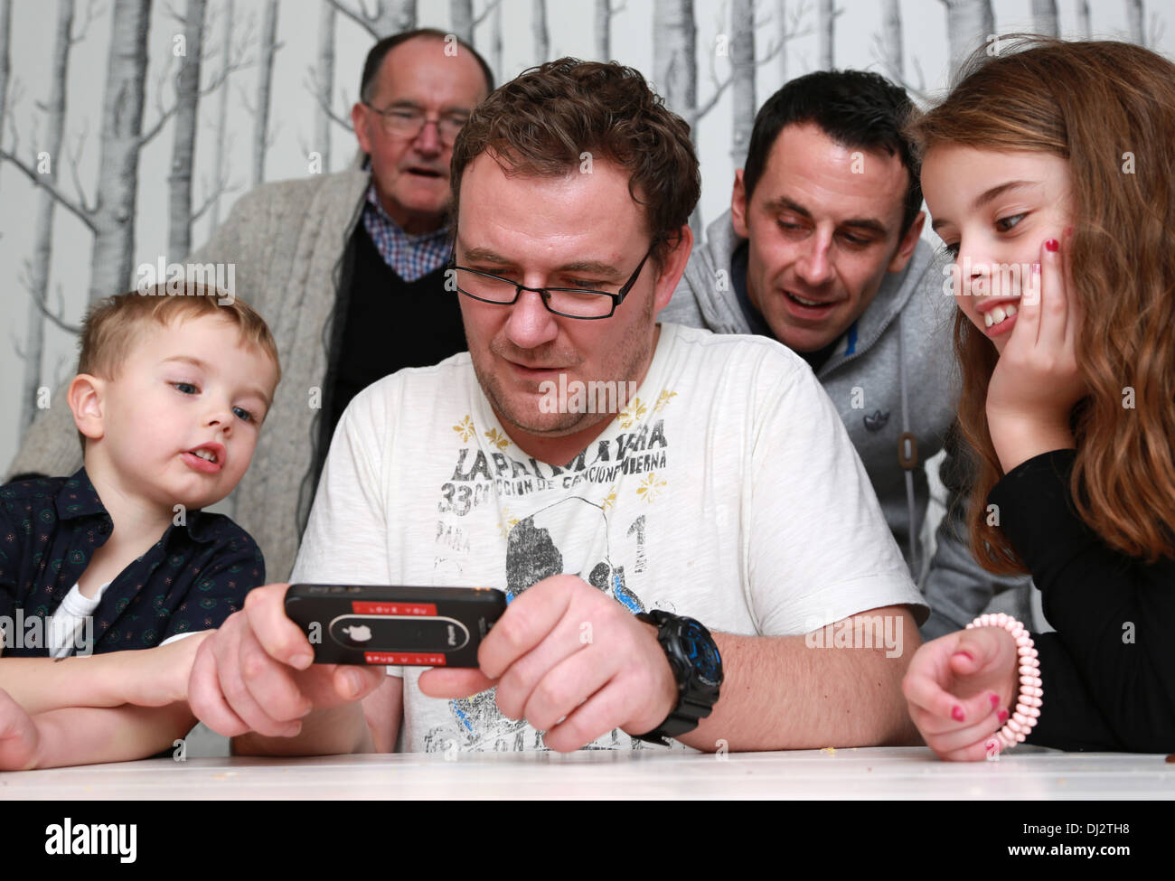 Family looking at a game Stock Photo