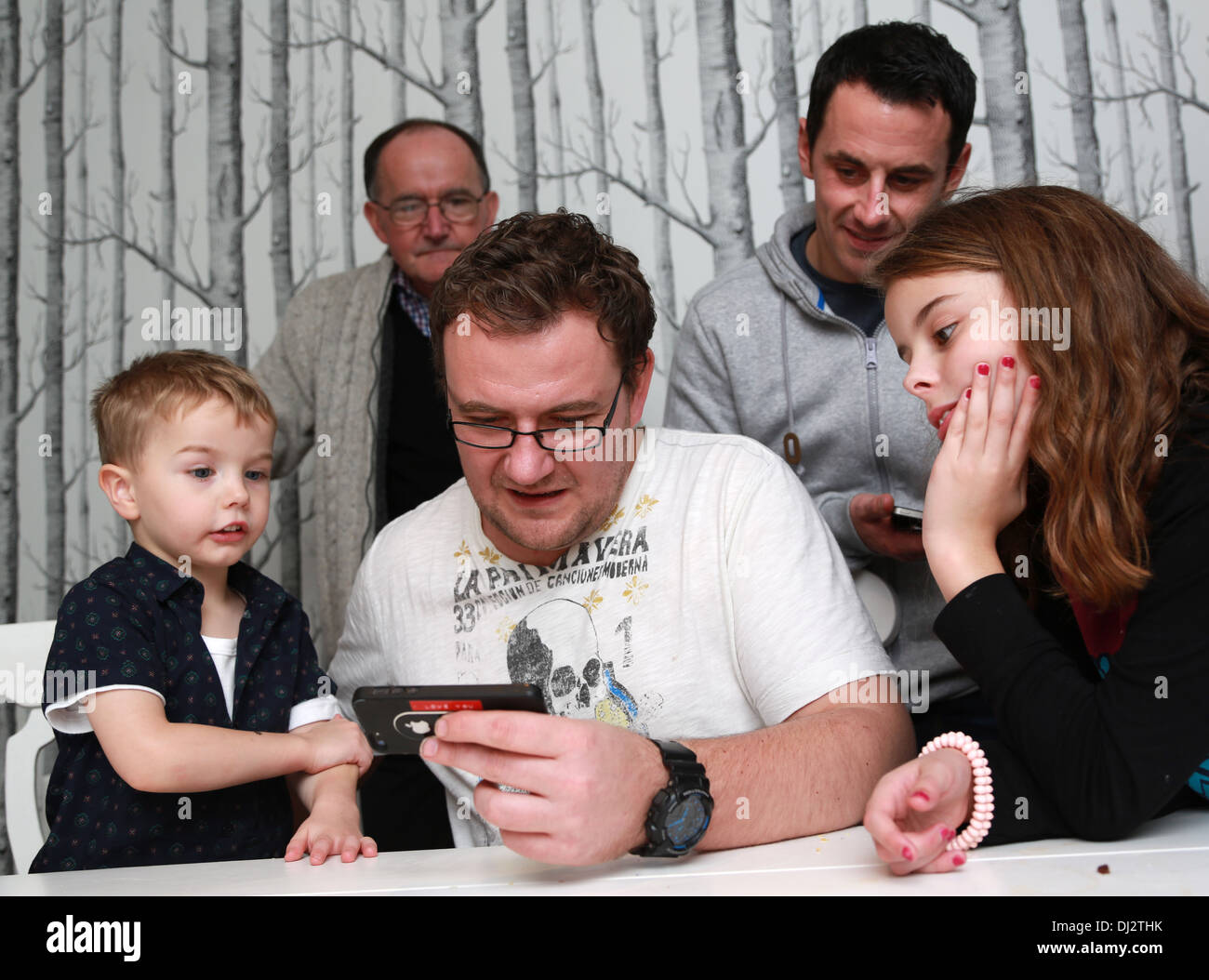 Family looking at a game Stock Photo