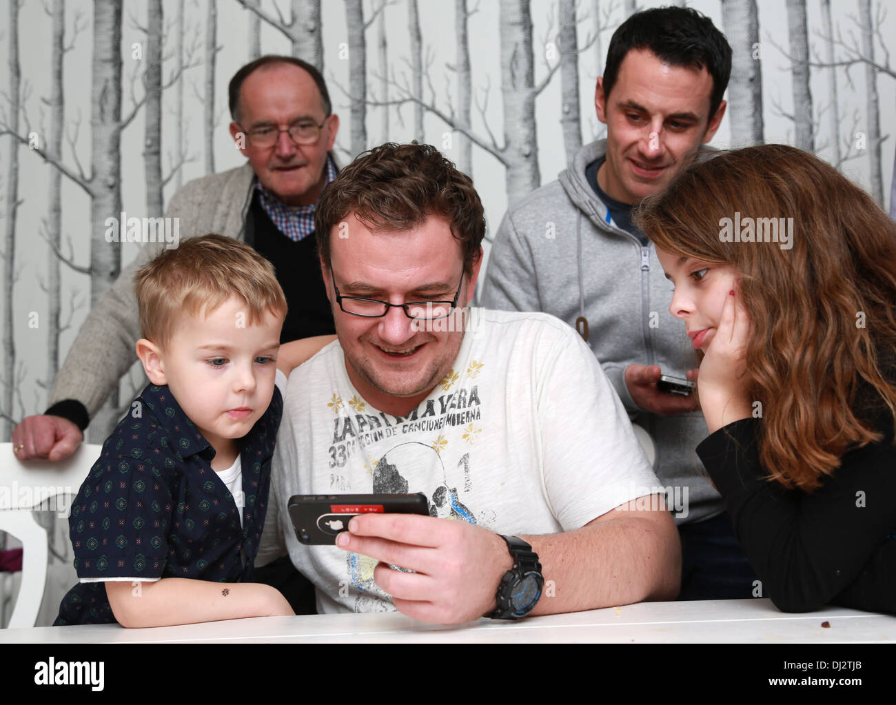 Family looking at a game Stock Photo