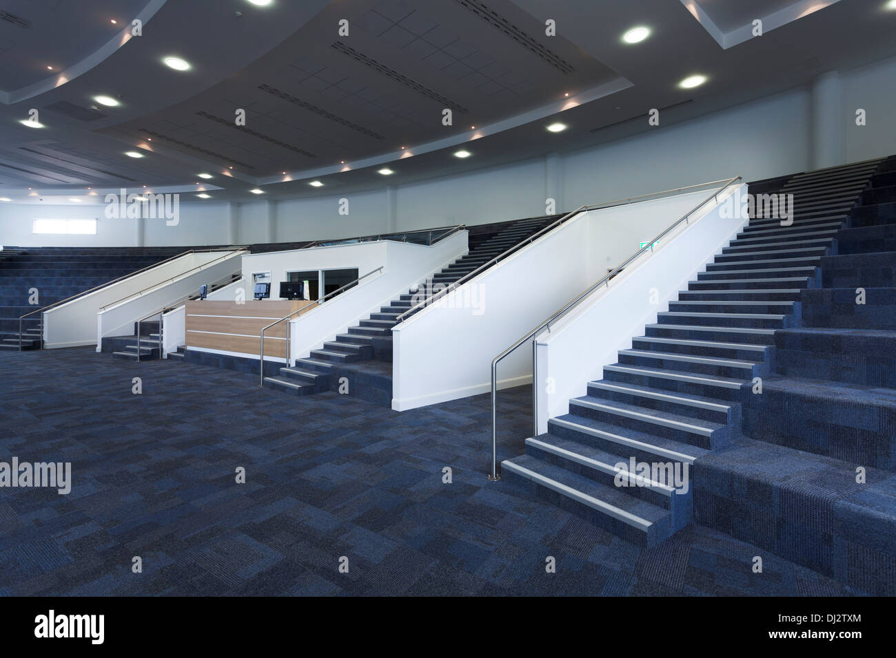 Empty tiered auditorium with audio visual control room. Stock Photo