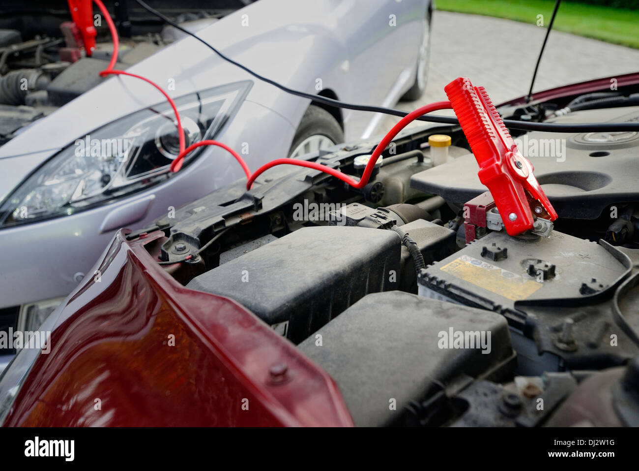 Charging the car battery with jumper cables Stock Photo Alamy