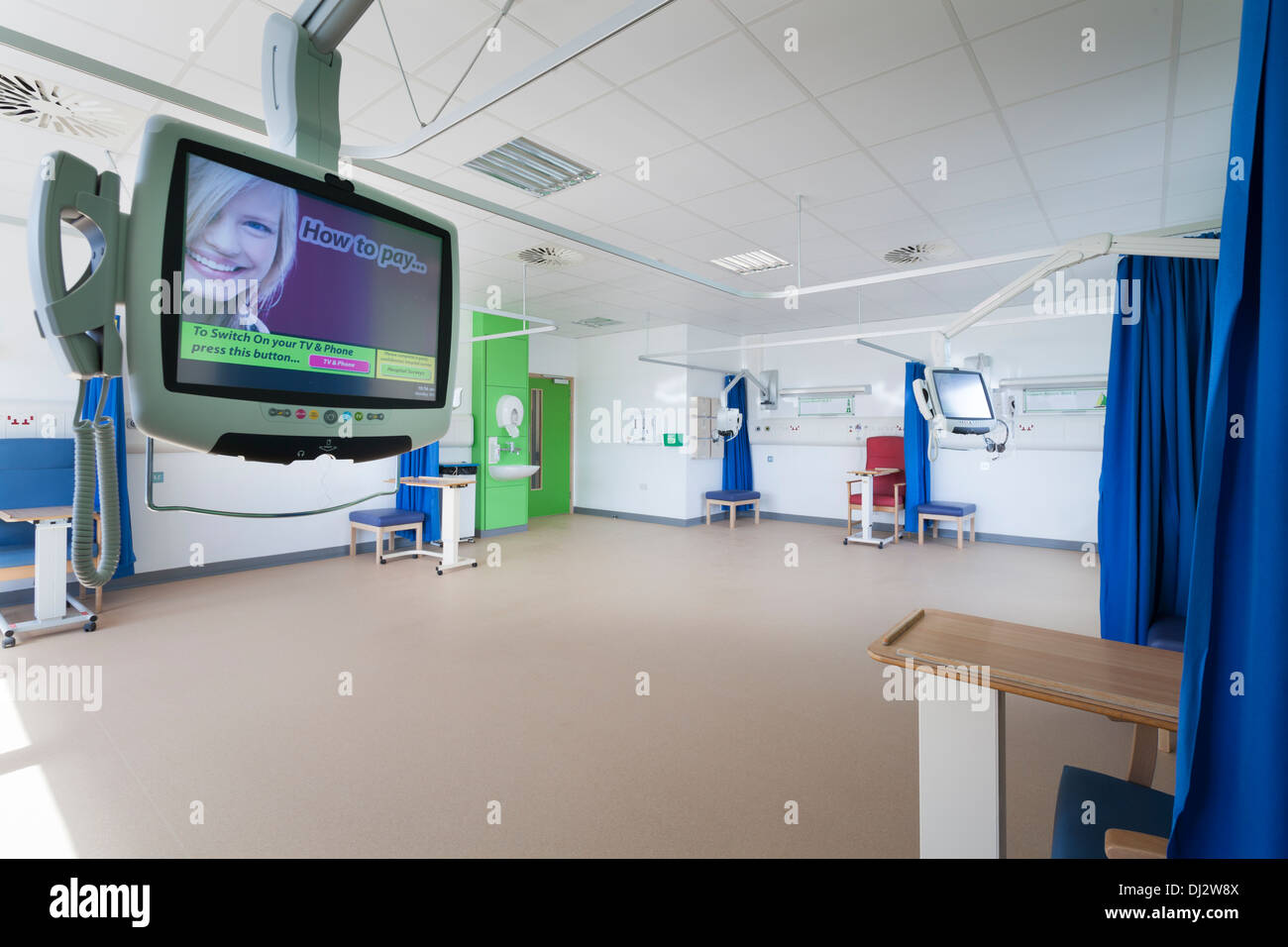 Empty refurbished hospital ward without beds with pay to view TV and Phone. Stock Photo