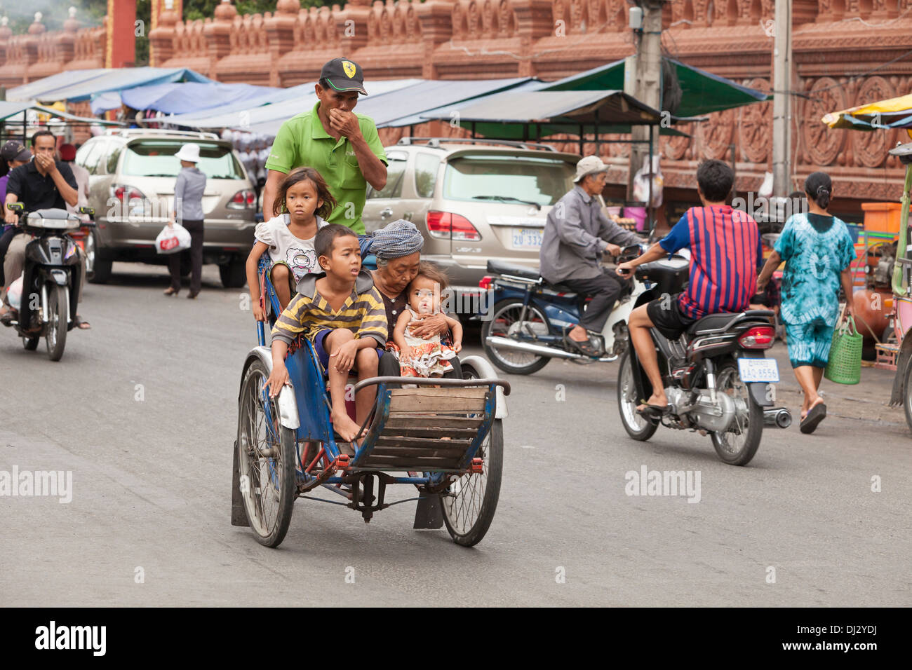 Cyclo with four passengers in Phnom Penh, Cambodia Stock Photo