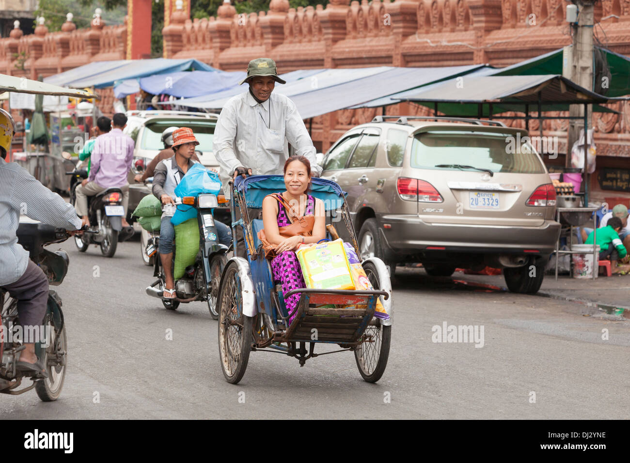 Cyclo with happy passenger in Phnom Penh, Cambodia Stock Photo