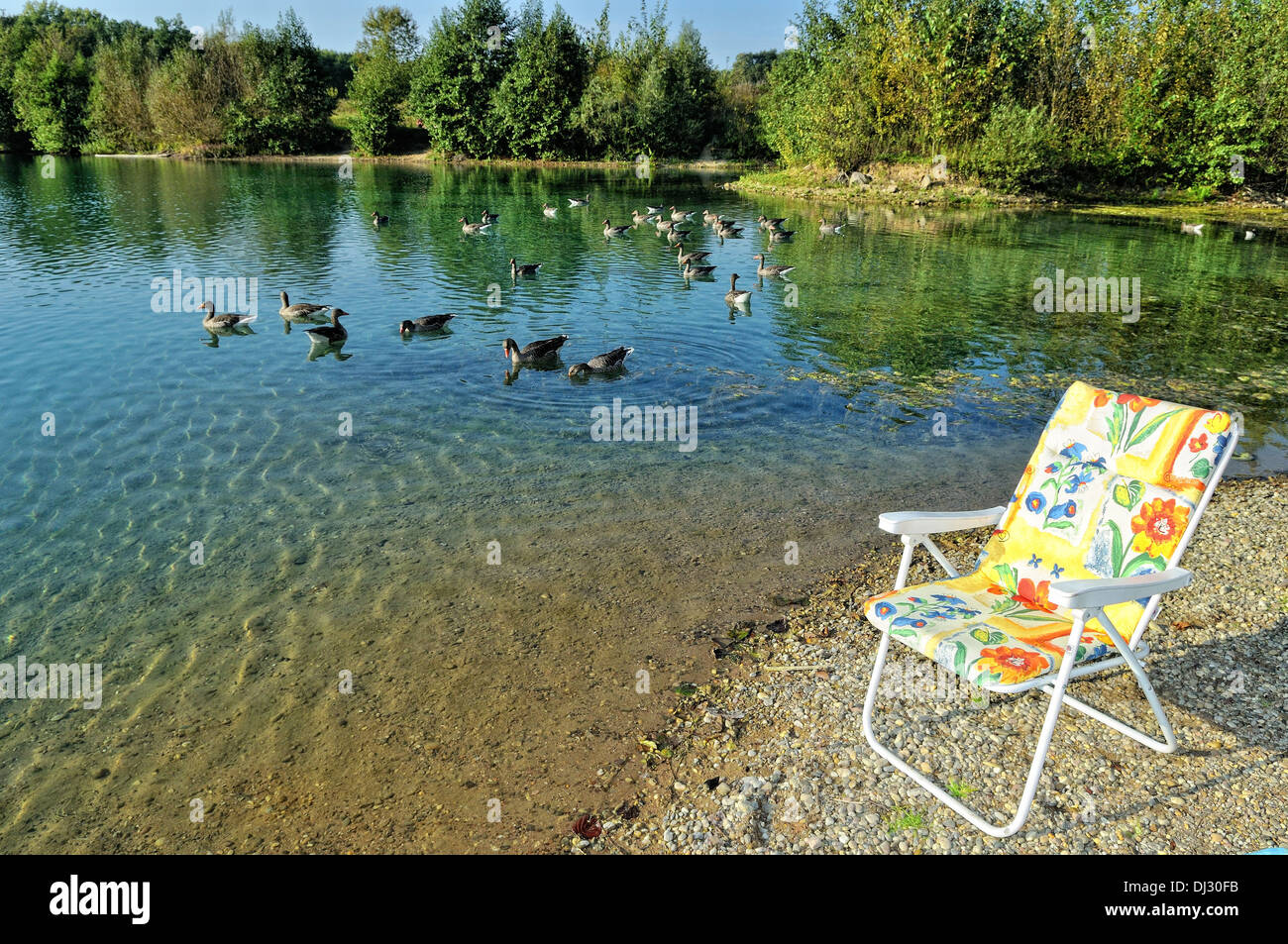 Folding chair by the lake Stock Photo