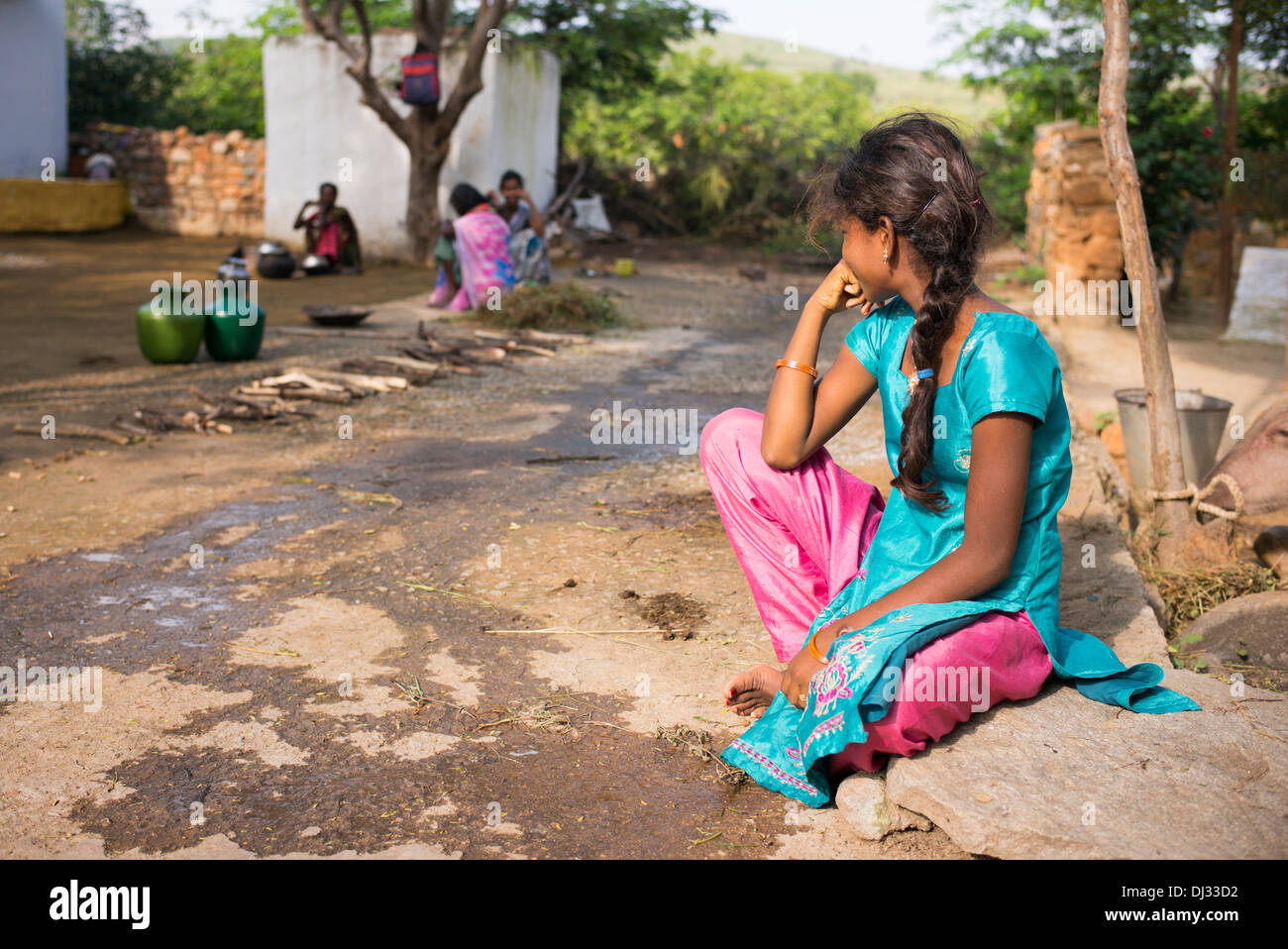 Indian teenage girl sat outside her rural Indian village home. Andhra Pradesh, India Stock Photo