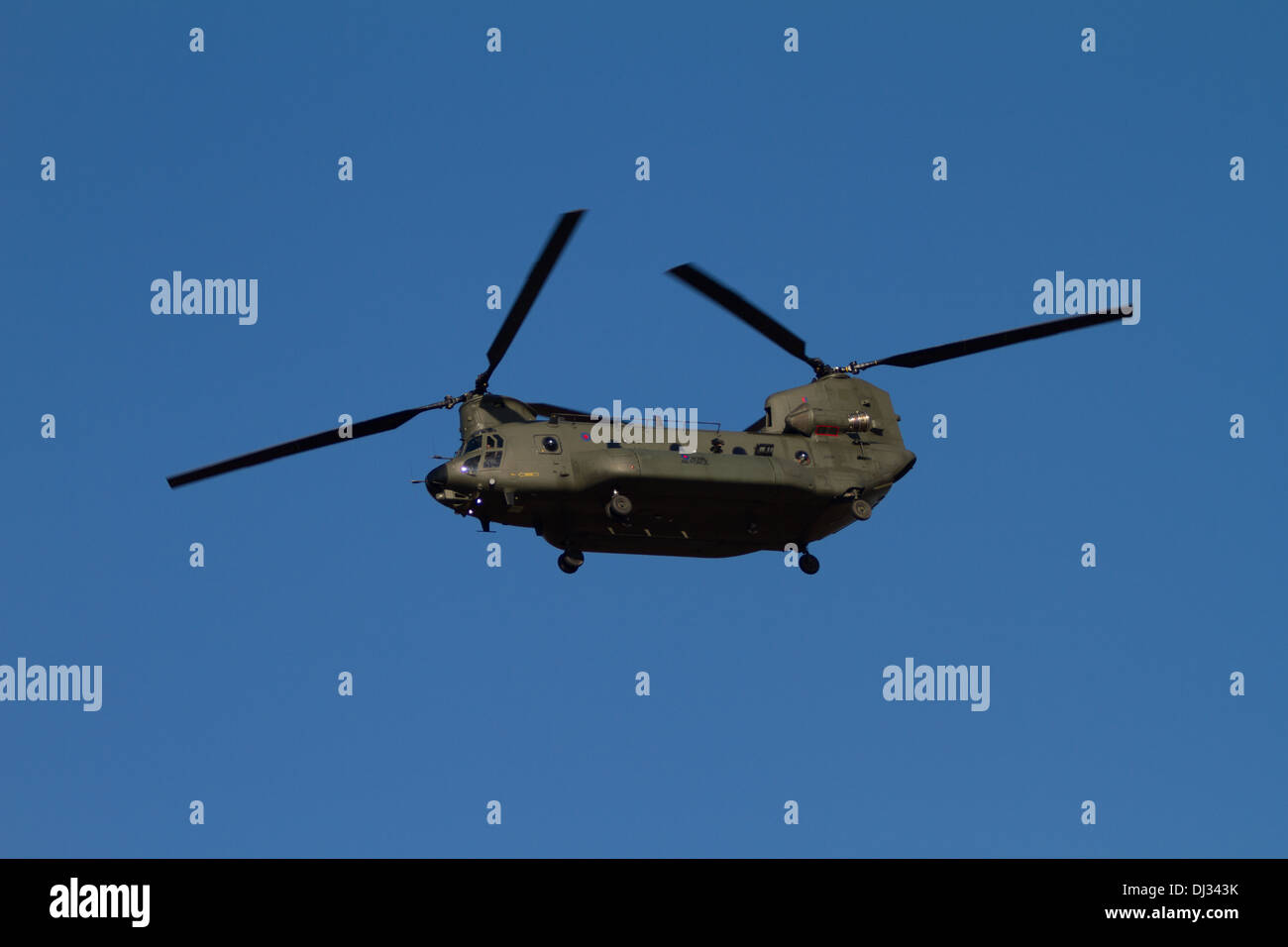 Boeing CH-47 Chinook Helicopter flying With A Blue Sky Stock Photo